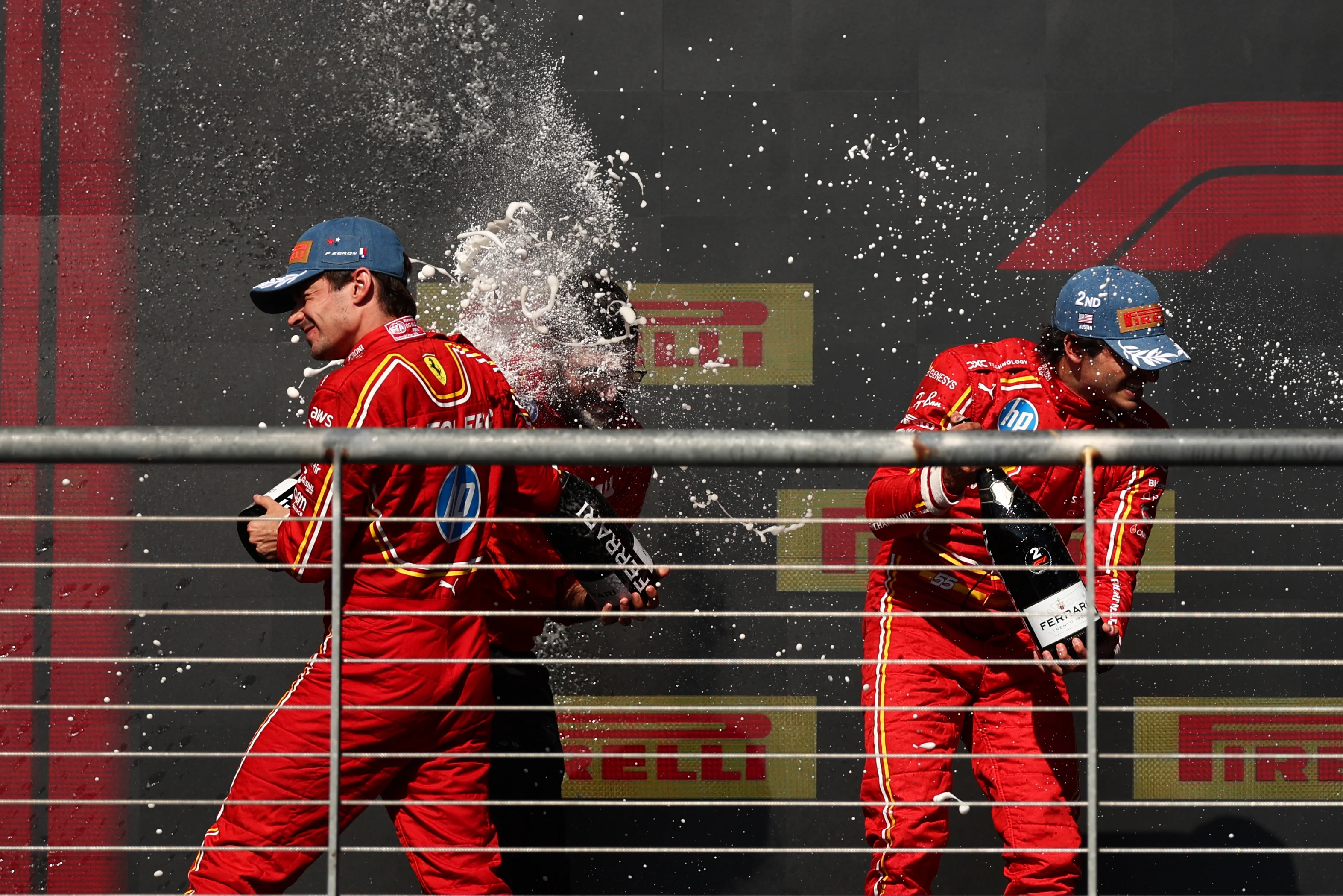 AUSTIN, TEXAS - OCTOBER 20: Race winner Charles Leclerc of Monaco and Ferrari and Second placed Carlos Sainz of Spain and Ferrari celebrate on the podium after the F1 Grand Prix of United States at Circuit of The Americas on October 20, 2024 in Austin, Texas. (Photo by Jared C. Tilton/Getty Images)