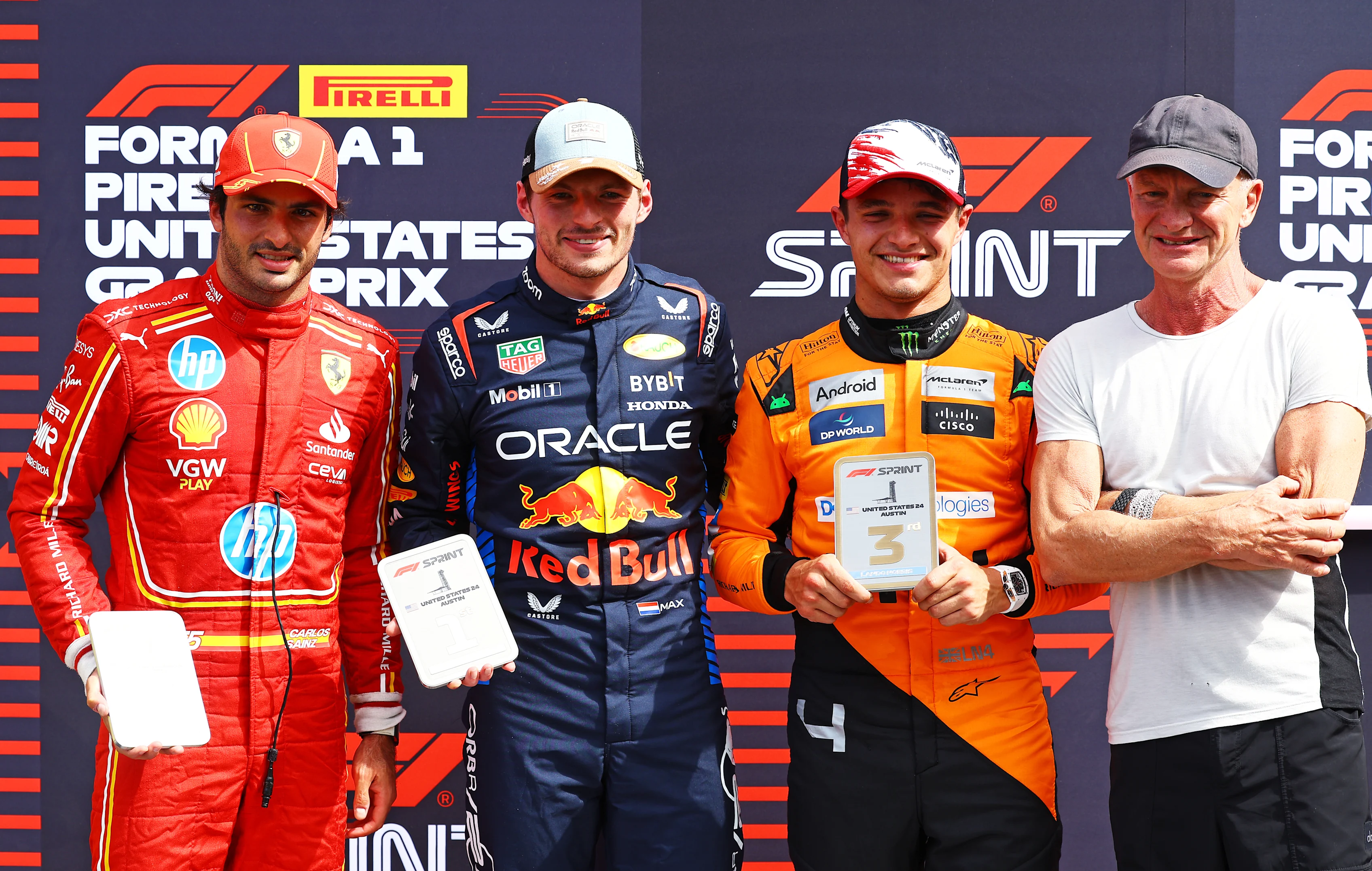 AUSTIN, TEXAS - OCTOBER 19: Sprint winner Max Verstappen, Second placed Carlos Sainz, Third placed Lando Norris and Sting pose for a photo in parc ferme during the Sprint at Circuit of The Americas. (Photo by Mark Thompson/Getty Images)