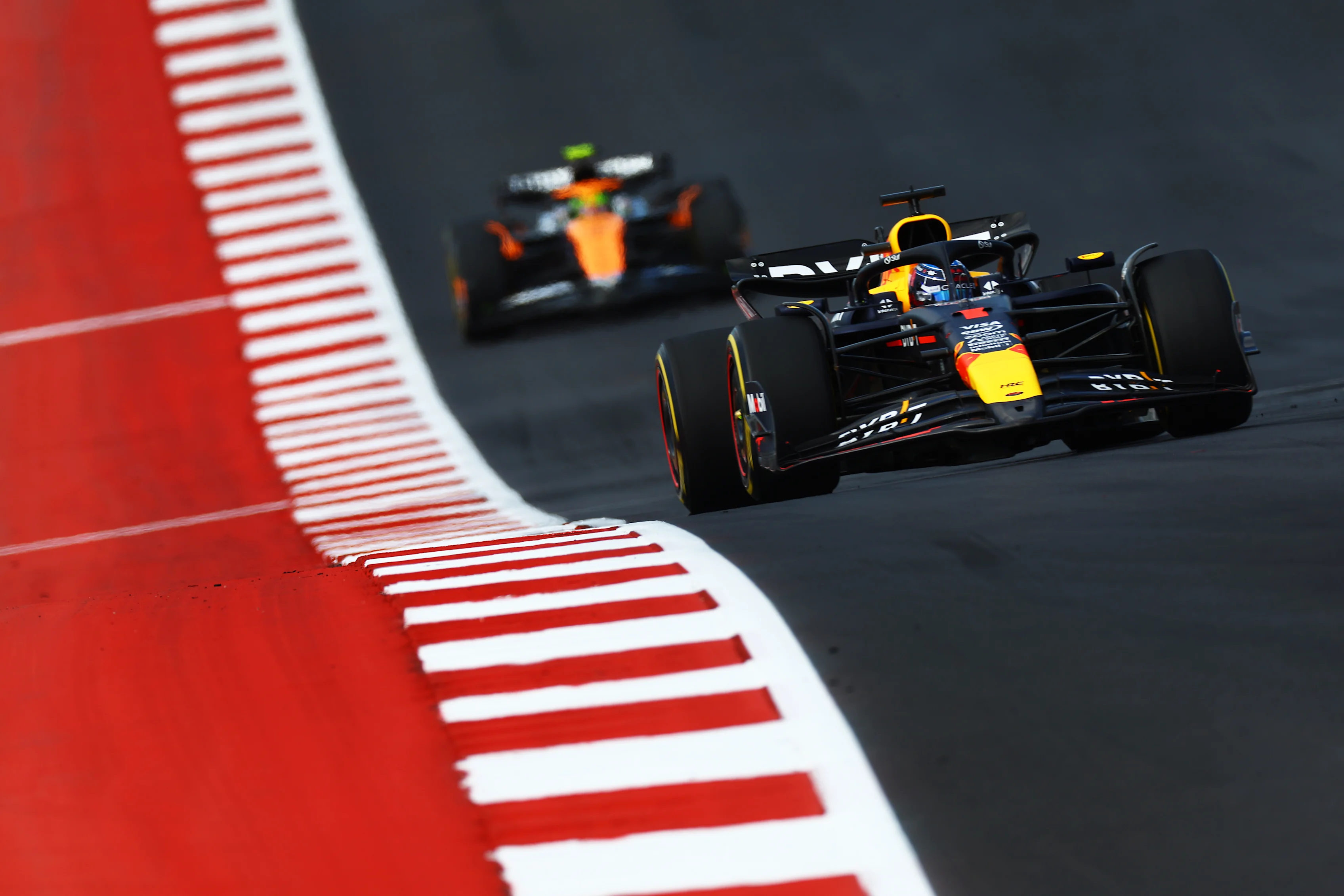 AUSTIN, TEXAS - OCTOBER 19: Max Verstappen of the Netherlands driving the (1) Oracle Red Bull Racing RB20 leads Lando Norris of Great Britain driving the (4) McLaren MCL38 Mercedes during the Sprint ahead of the F1 Grand Prix of United States at Circuit of The Americas on October 19, 2024 in Austin, Texas. (Photo by Mark Thompson/Getty Images)