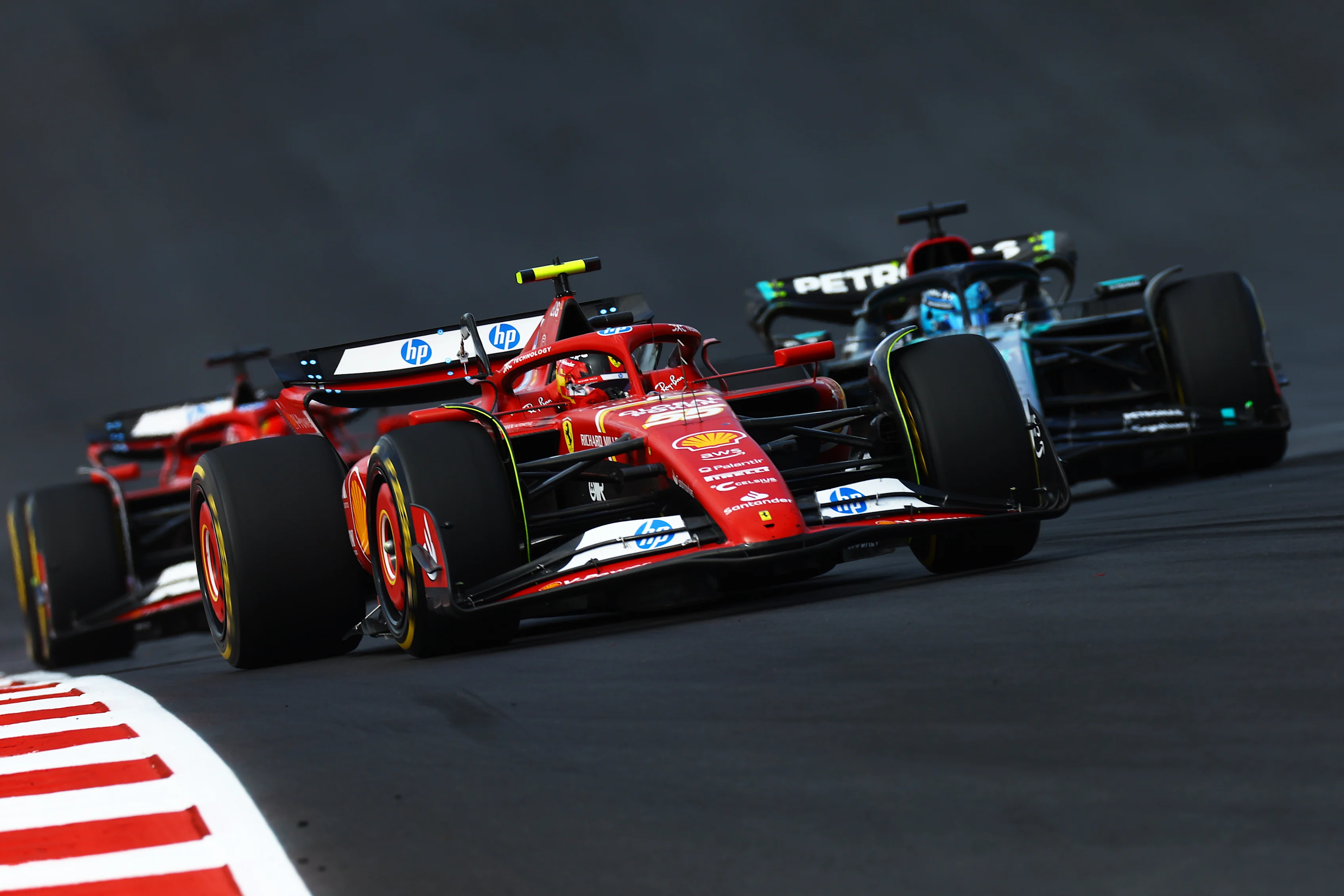 AUSTIN, TEXAS - OCTOBER 19: Carlos Sainz of Spain driving (55) the Ferrari SF-24 leads George Russell of Great Britain driving the (63) Mercedes AMG Petronas F1 Team W15 and Charles Leclerc of Monaco driving the (16) Ferrari SF-24 during the Sprint ahead of the F1 Grand Prix of United States at Circuit of The Americas on October 19, 2024 in Austin, Texas. (Photo by Mark Thompson/Getty Images)