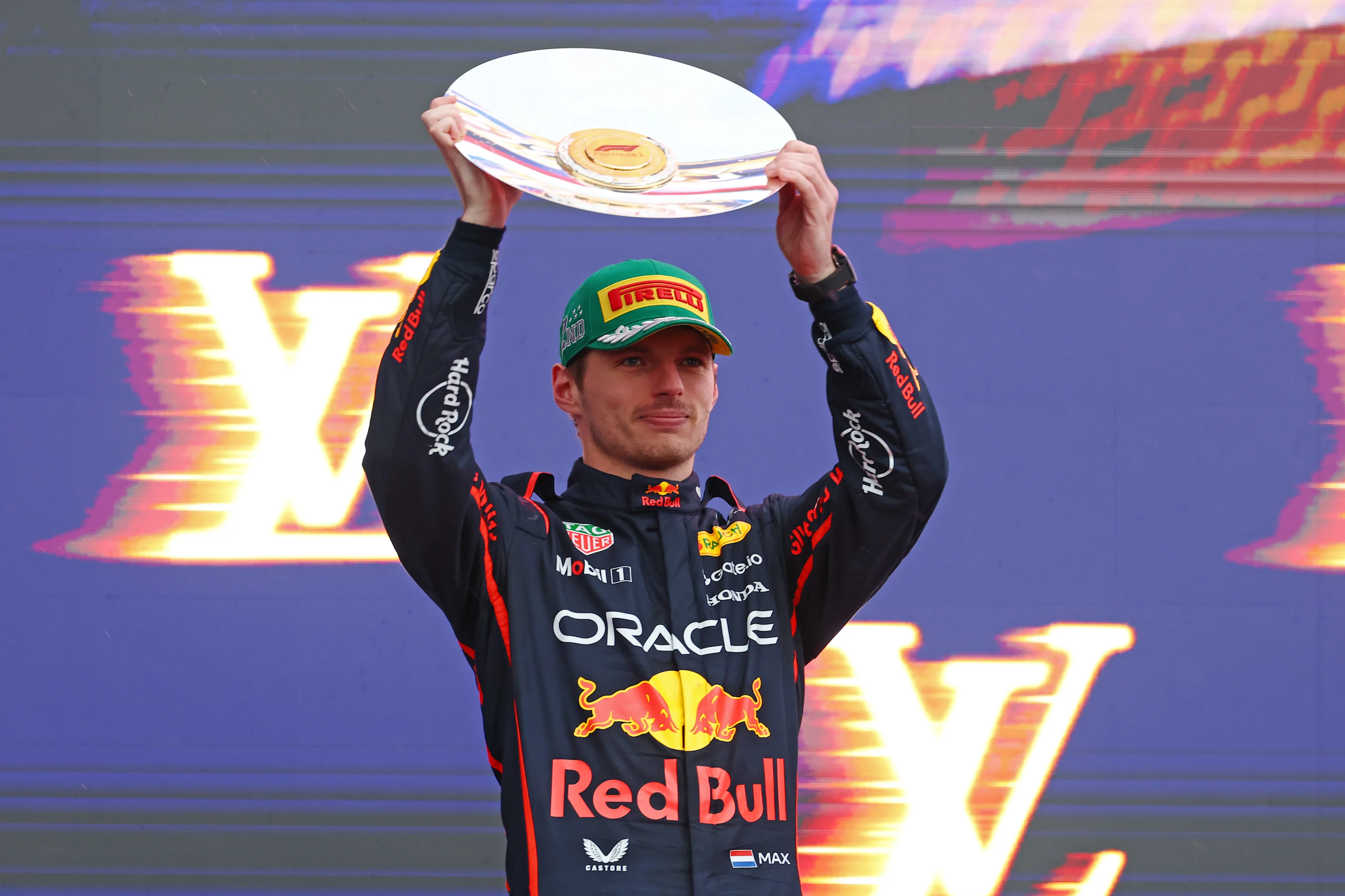MELBOURNE, AUSTRALIA - MARCH 16: Second placed Max Verstappen of the Netherlands and Oracle Red Bull Racing on the podium with his trophy during the F1 Grand Prix of Australia at Albert Park Grand Prix Circuit on March 16, 2025 in Melbourne, Australia. (Photo by Clive Rose/Getty Images)