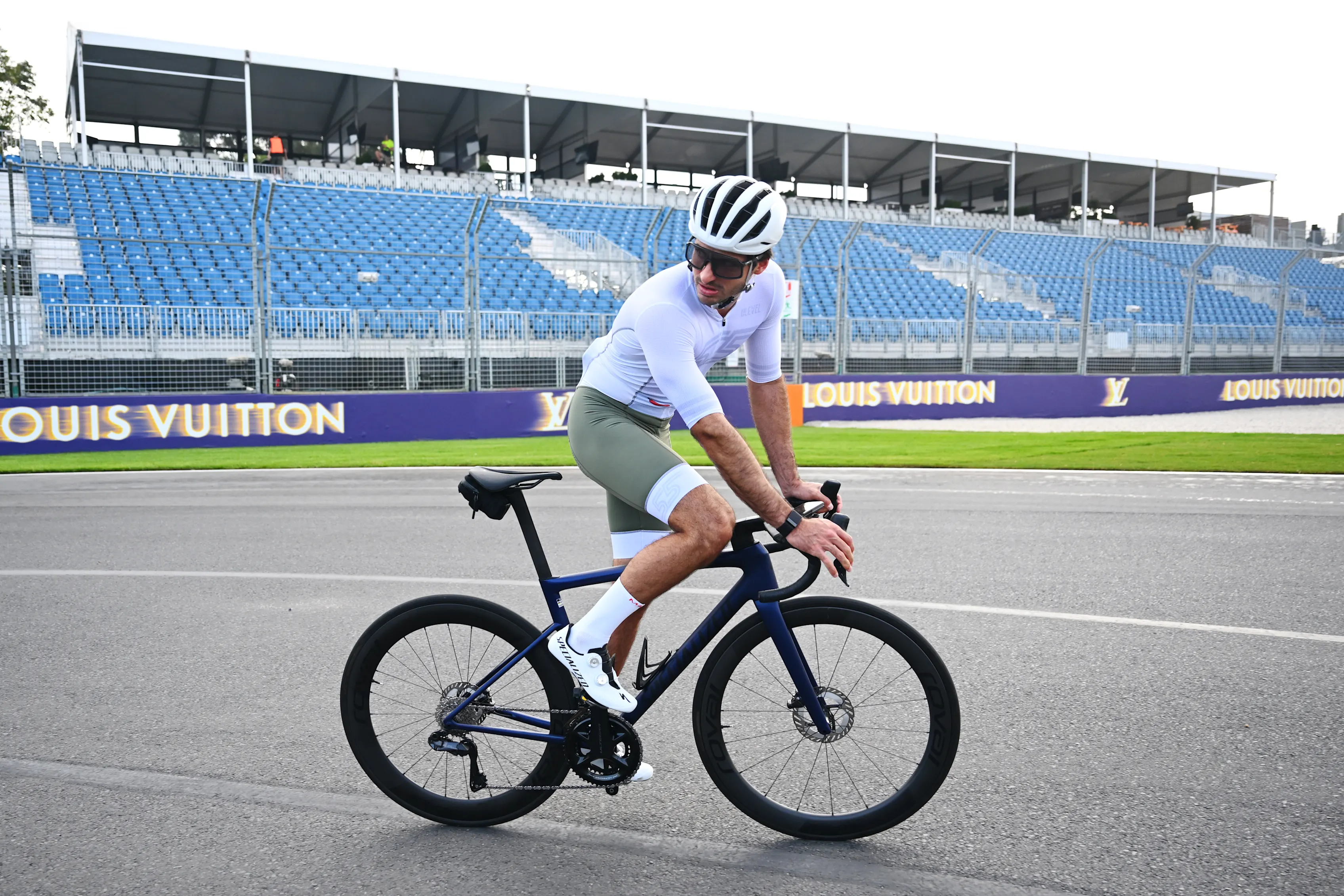 MELBOURNE, AUSTRALIA - MARCH 12: Carlos Sainz of Spain and Williams rides a bicycle on track during