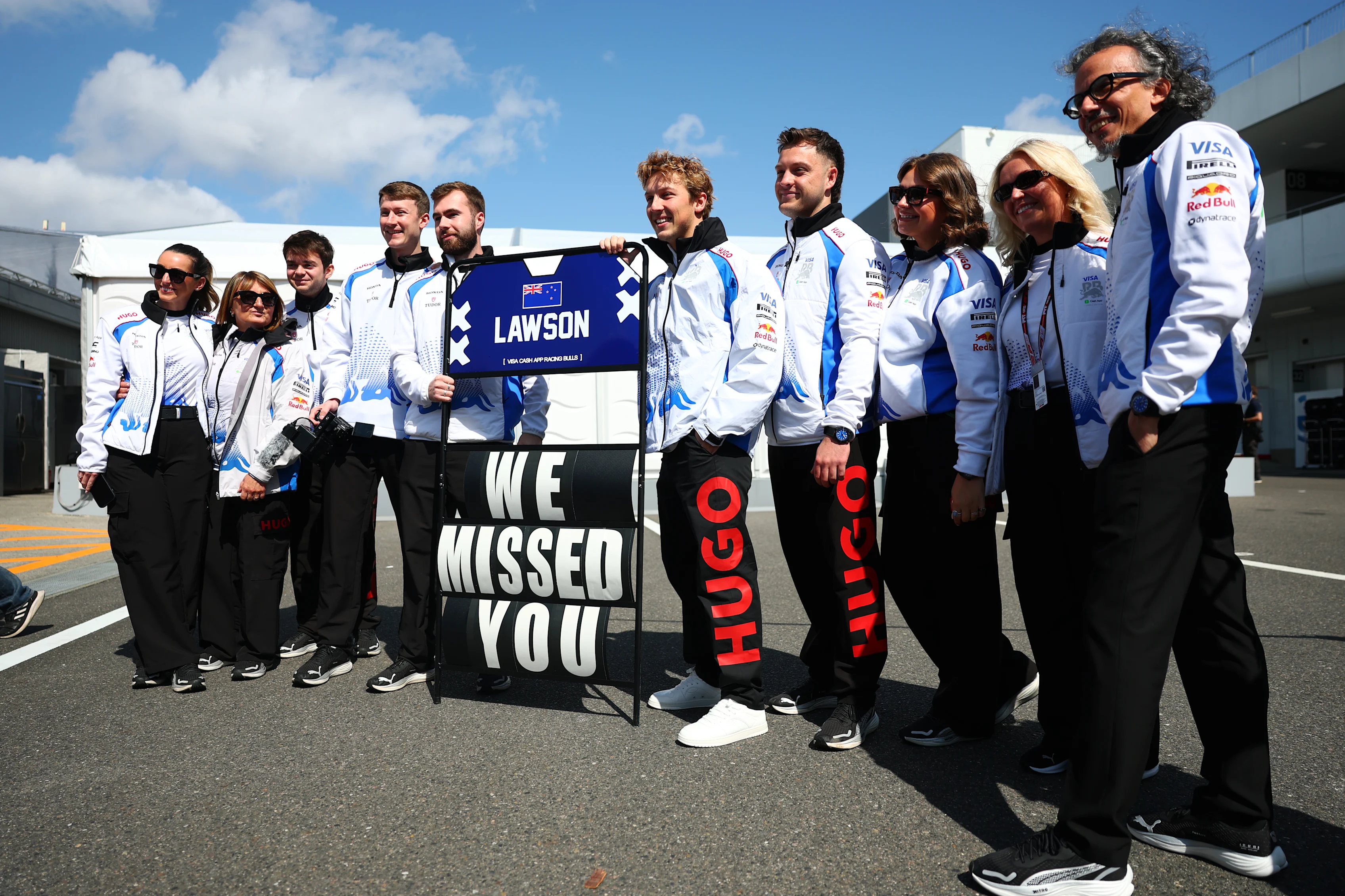 SUZUKA, JAPAN - APRIL 03: The Visa Cash App Racing Bulls team welcome Liam Lawson of New Zealand
