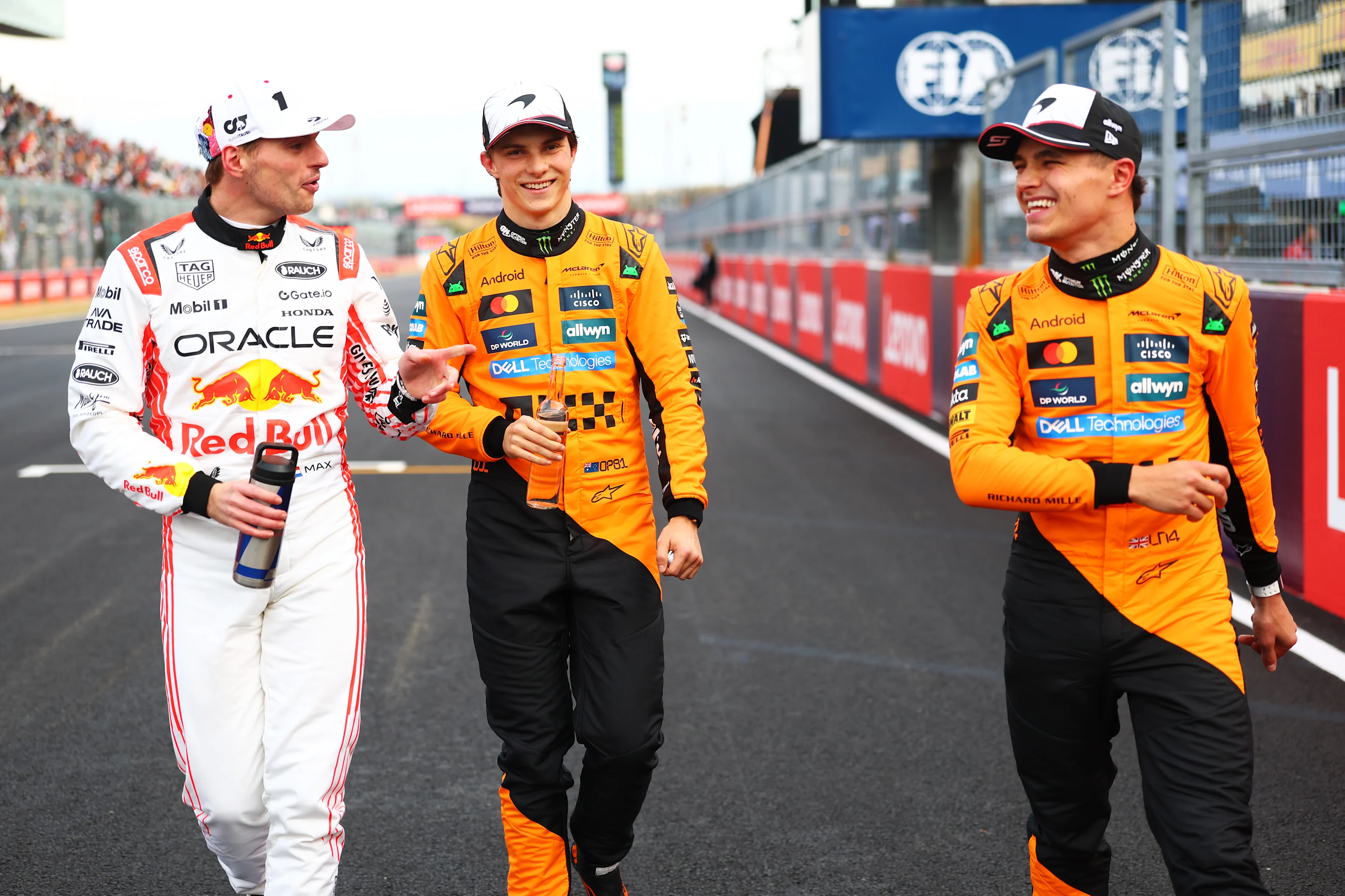 SUZUKA, JAPAN - APRIL 05: Pole position qualifier Max Verstappen of the Netherlands and Oracle Red Bull Racing Third placed qualifier Oscar Piastri of Australia and McLaren and Second placed qualifier Lando Norris of Great Britain and McLaren talk in parc ferme during qualifying ahead of the F1 Grand Prix of Japan at Suzuka Circuit on April 05, 2025 in Suzuka, Japan. (Photo by Bryn Lennon - Formula 1/Formula 1 via Getty Images)