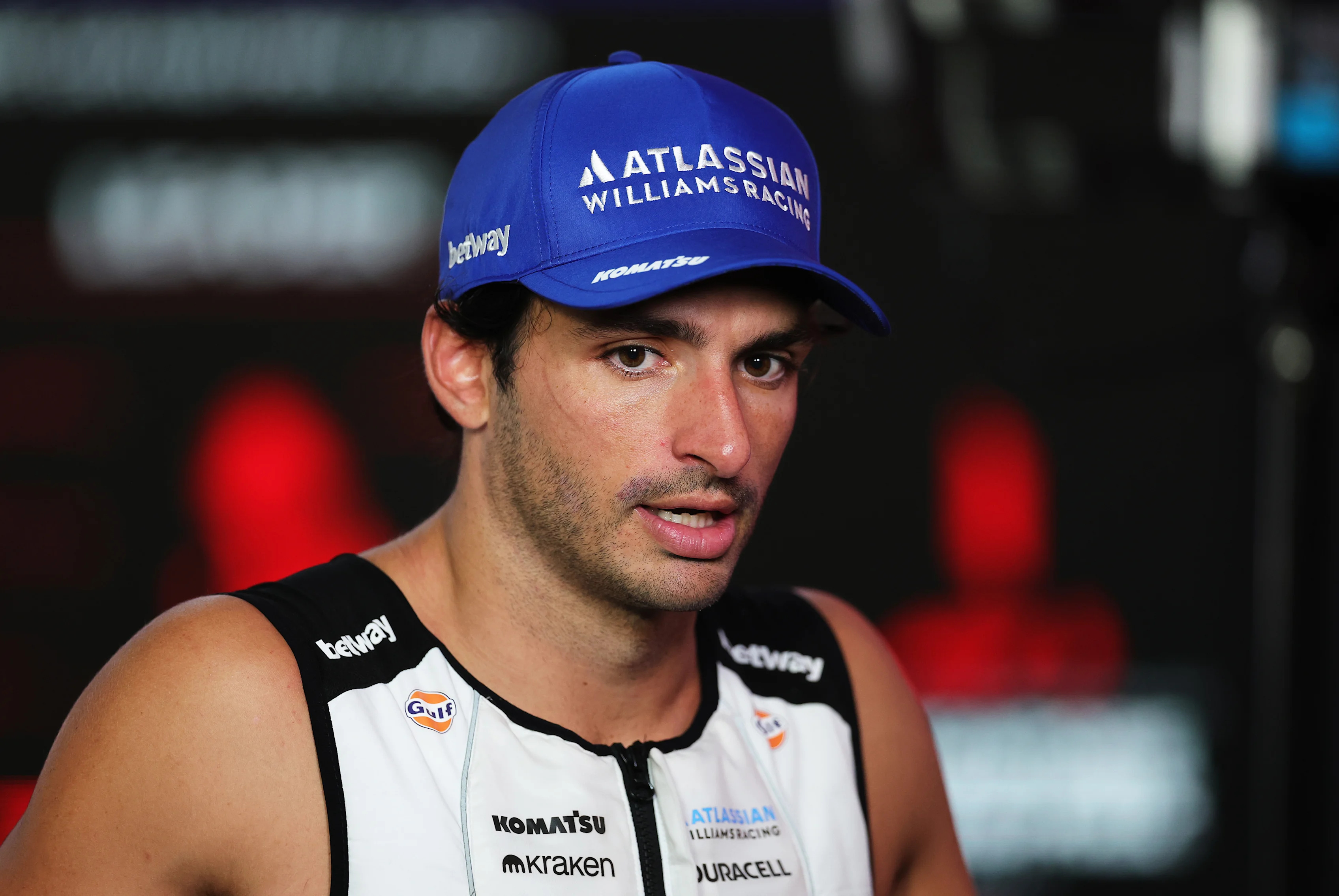 SINGAPORE, SINGAPORE - OCTOBER 05: Tenth placed Carlos Sainz of Spain and Williams talks to the