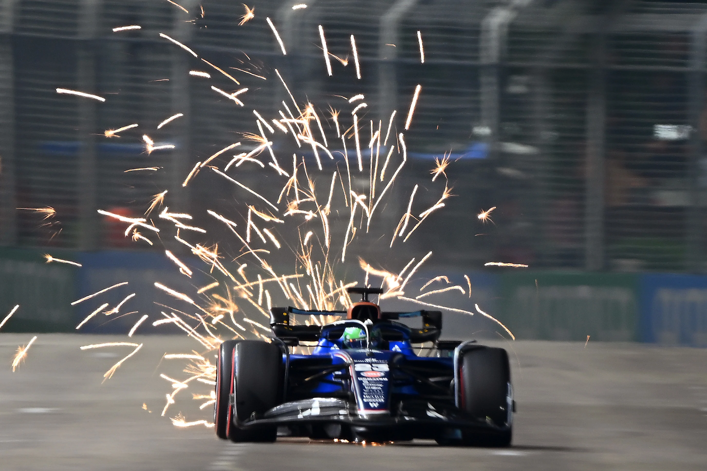 SINGAPORE, SINGAPORE - OCTOBER 04: Sparks fly behind Alexander Albon of Thailand driving the (23)