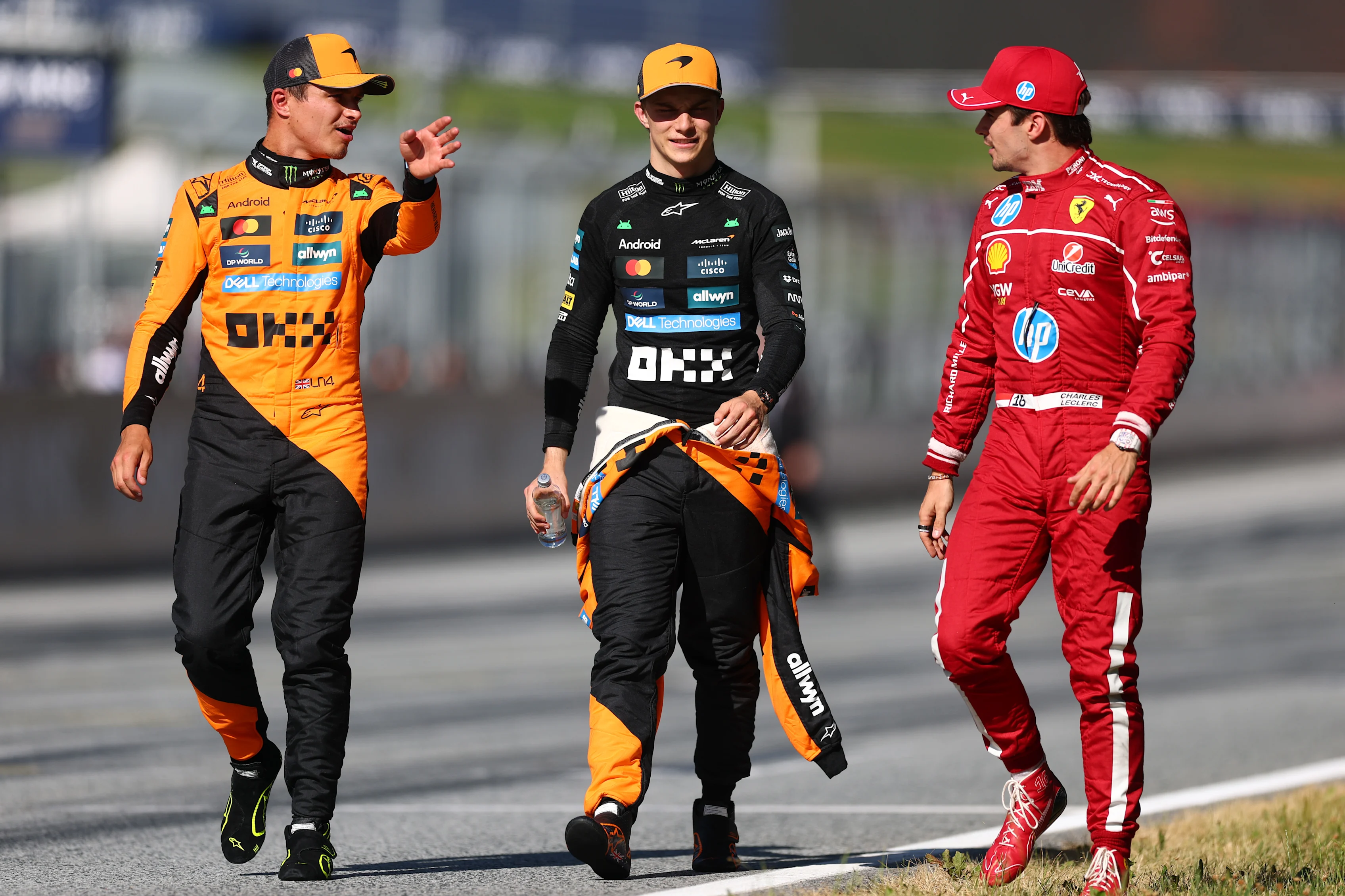 Lando Norris, Charles Leclerc and Oscar Piastri walk together during qualifying ahead of the F1 Grand Prix of Austria at Red Bull Ring on June 28, 2025 in Spielberg, Austria. (Photo by Clive Rose - Formula 1/Formula 1 via Getty Images)