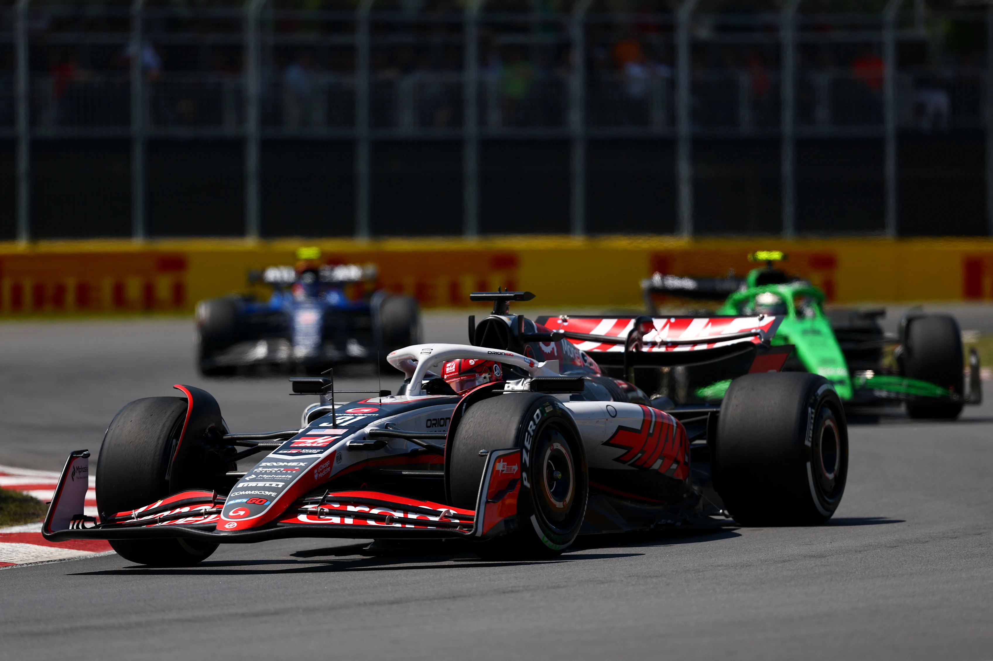 MONTREAL, QUEBEC - JUNE 15: Esteban Ocon of France driving the (31) Haas F1 VF-25 Ferrari leads Gabriel Bortoleto of Brazil driving the (5) Kick Sauber C45 Ferrari and Carlos Sainz of Spain driving the (55) Williams FW47 Mercedes on track during the F1 Grand Prix of Canada at Circuit Gilles-Villeneuve on June 15, 2025 in Montreal, Quebec. (Photo by Clive Rose/Getty Images)