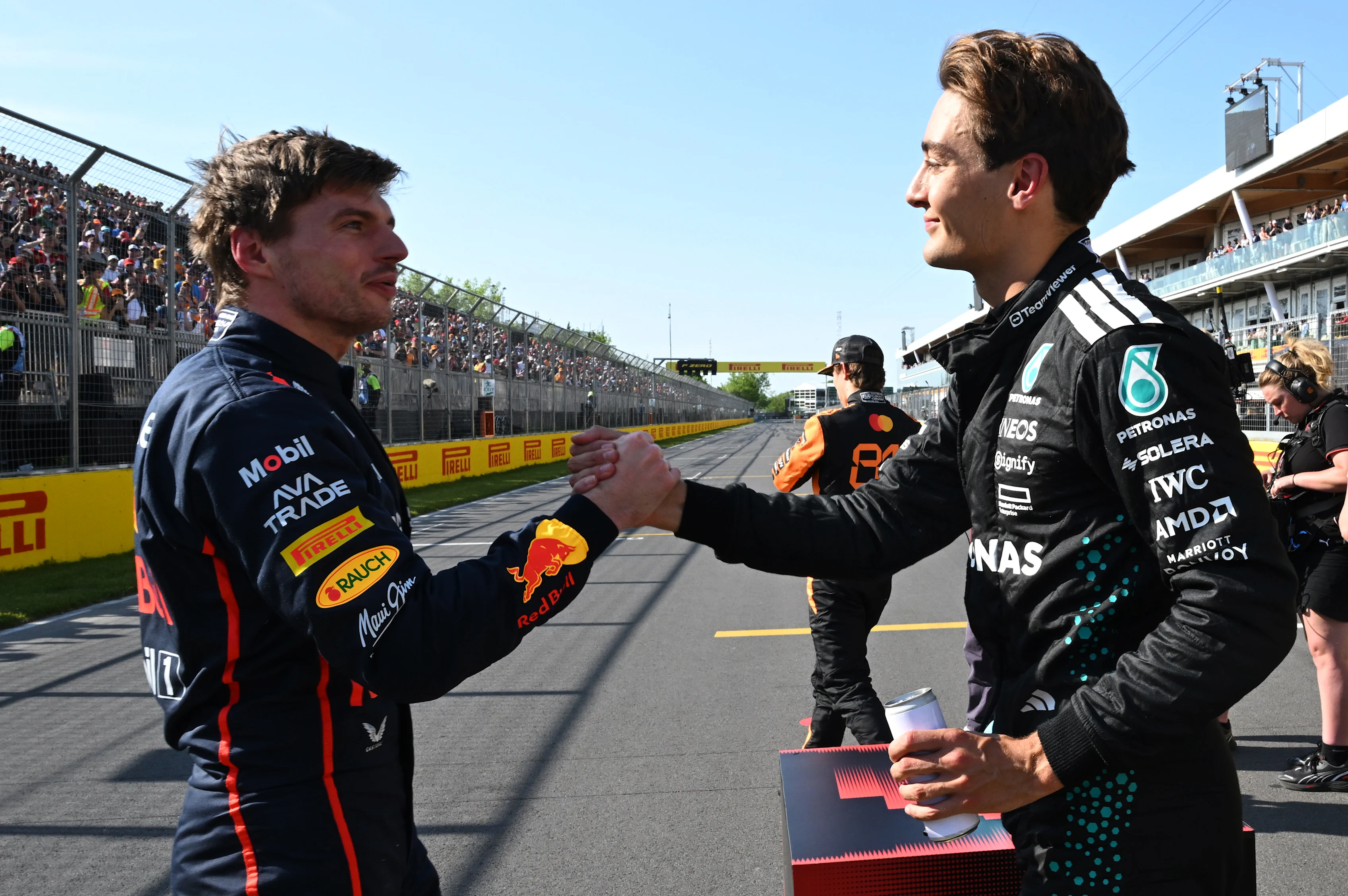 MONTREAL, QUEBEC - JUNE 14: Pole position qualifier George Russell of Great Britain and Mercedes AMG Petronas F1 Team and Second placed qualifier Max Verstappen of the Netherlands and Oracle Red Bull Racing shake hands in parc ferme during qualifying ahead of the F1 Grand Prix of Canada at Circuit Gilles-Villeneuve on June 14, 2025 in Montreal, Quebec. (Photo by Mark Sutton - Formula 1/Formula 1 via Getty Images)