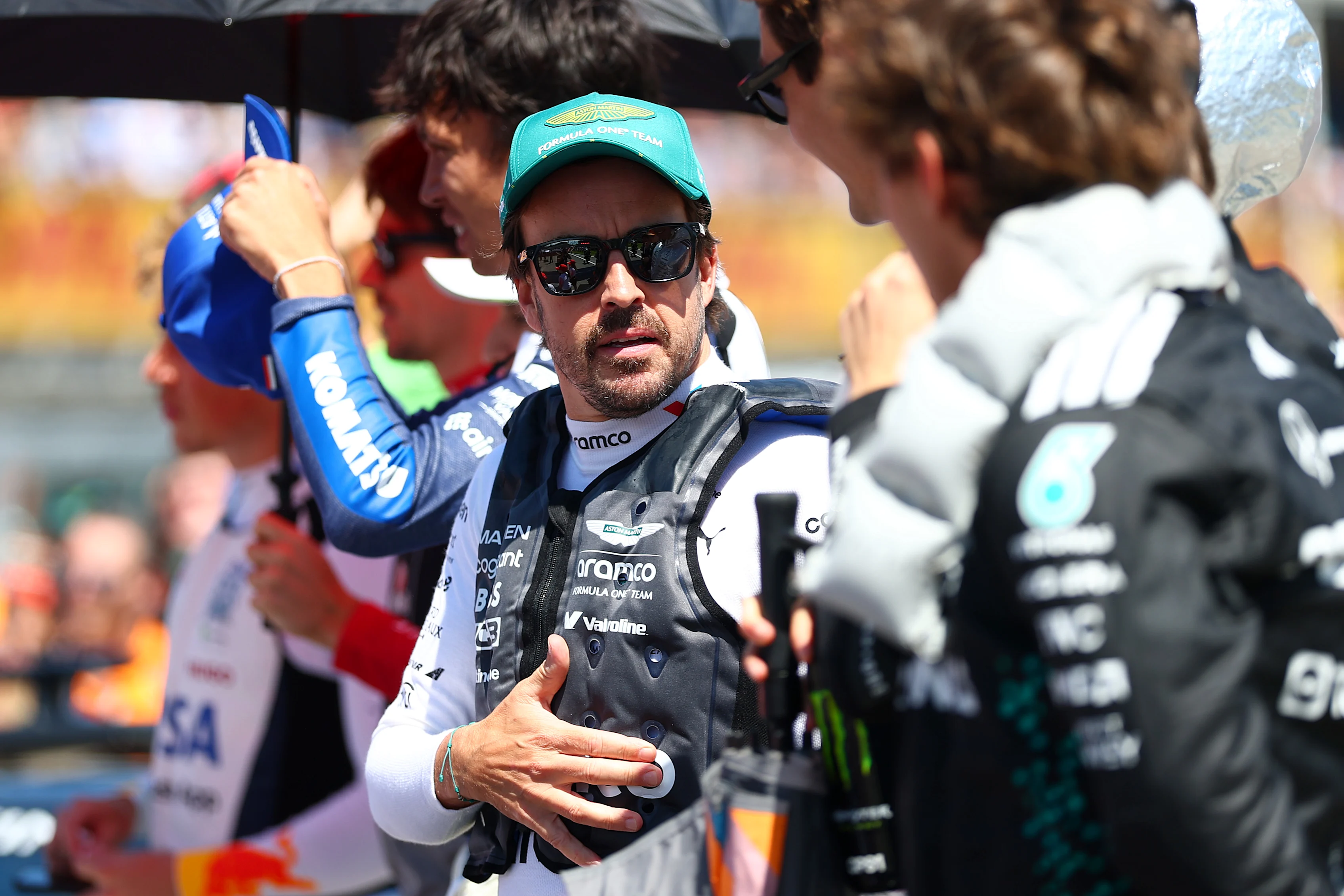 IMOLA, ITALY - MAY 18: Fernando Alonso of Spain and Aston Martin F1 Team and George Russell of Great Britain and Mercedes AMG Petronas F1 Team talk on the grid during the F1 Grand Prix of Emilia-Romagna at Autodromo Internazionale Enzo e Dino Ferrari on May 18, 2025 in Imola, Italy. (Photo by Bryn Lennon - Formula 1/Formula 1 via Getty Images)