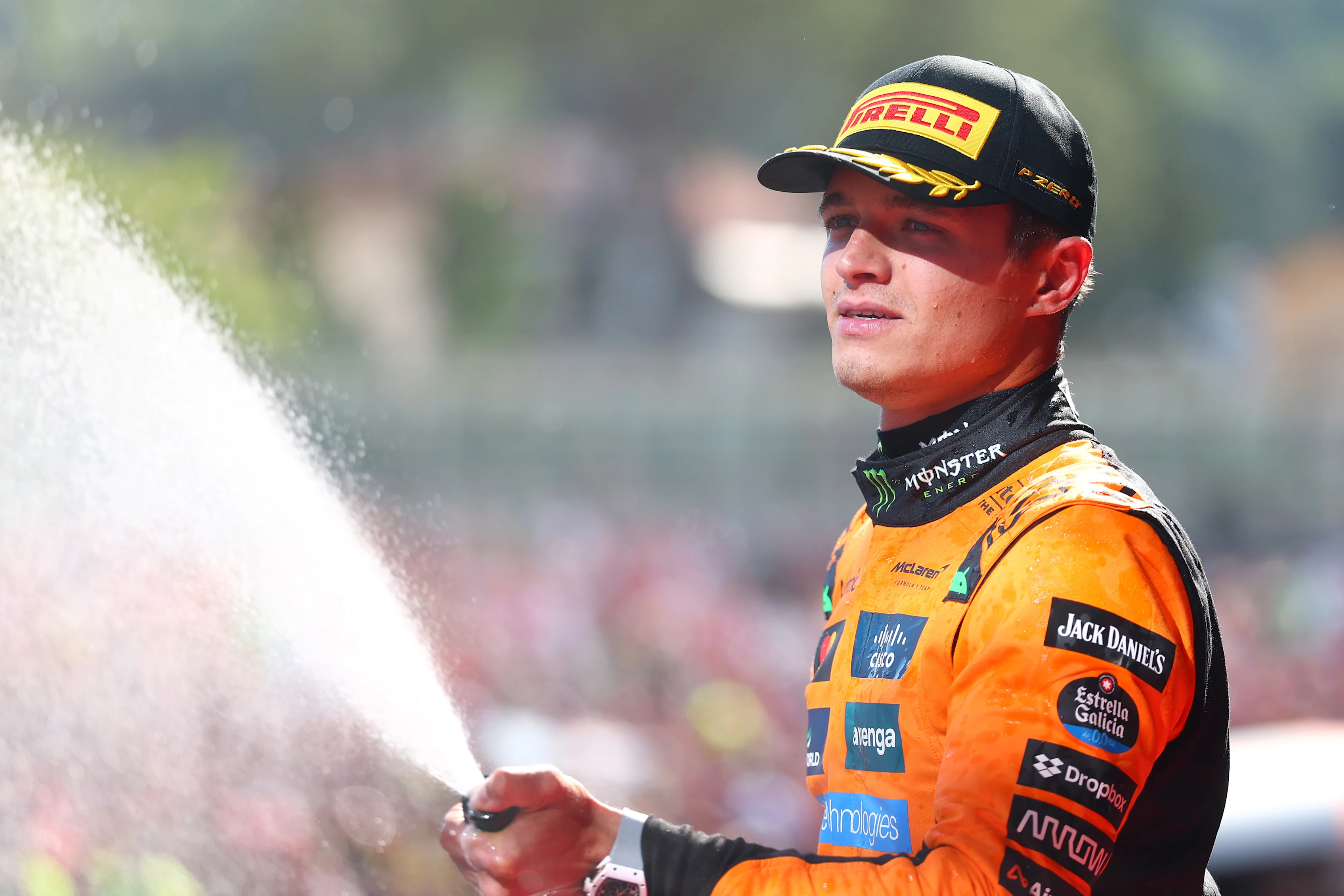 IMOLA, ITALY - MAY 18: Second placed Lando Norris of Great Britain and McLaren sprays Champagne on the podium during the F1 Grand Prix of Emilia-Romagna at Autodromo Internazionale Enzo e Dino Ferrari on May 18, 2025 in Imola, Italy. (Photo by Bryn Lennon - Formula 1/Formula 1 via Getty Images)