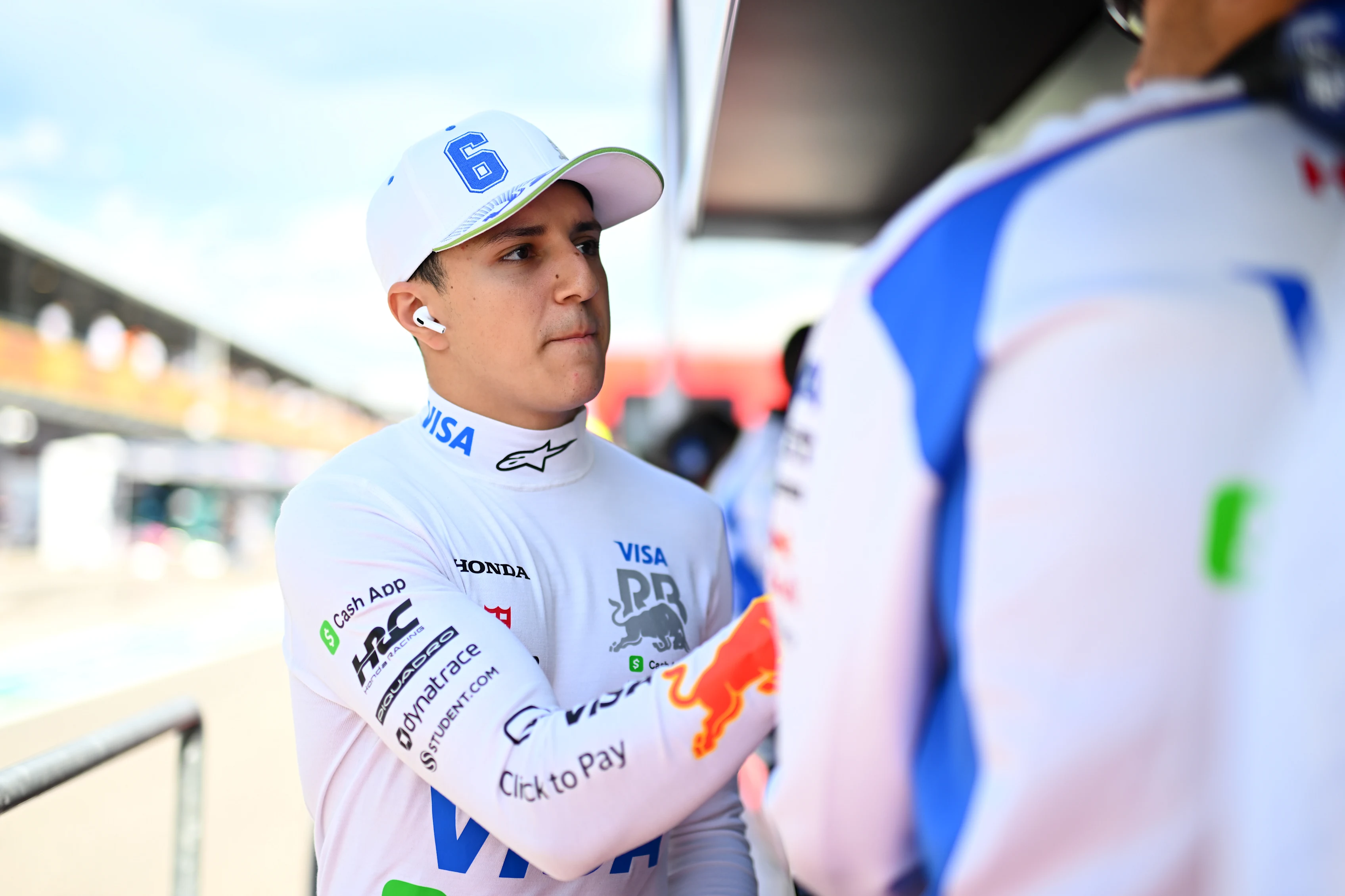 IMOLA, ITALY - MAY 17: Isack Hadjar of France and Visa Cash App Racing Bulls greets a teammate on the pit wall during qualifying ahead of the F1 Grand Prix of Emilia-Romagna at Autodromo Internazionale Enzo e Dino Ferrari on May 17, 2025 in Imola, Italy. (Photo by Rudy Carezzevoli/Getty Images)