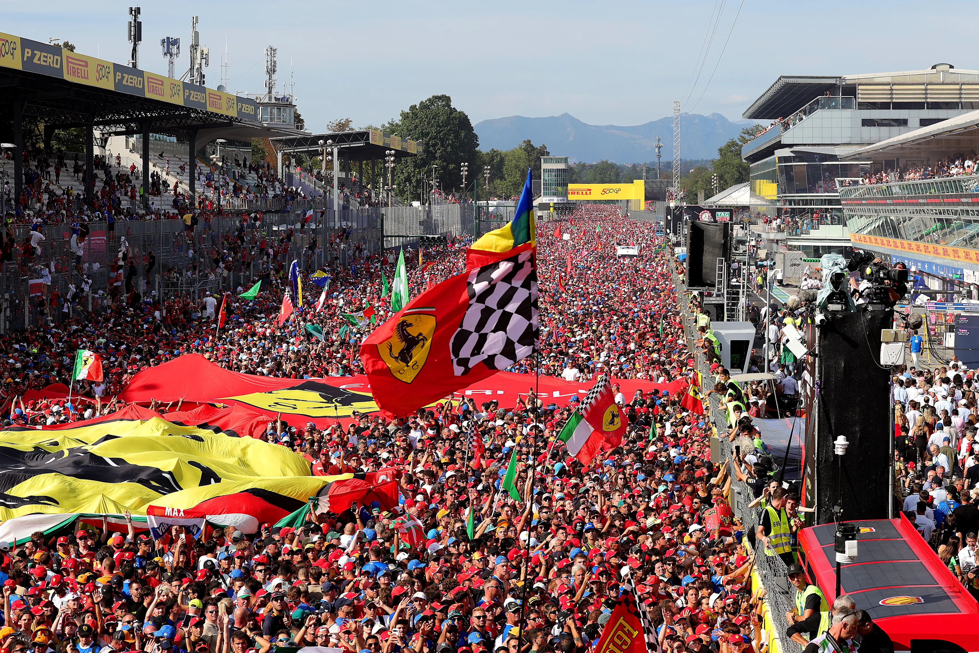 MONZA, ITALY - SEPTEMBER 07: Ferrari fans flood the track for the podium ceremony during the F1