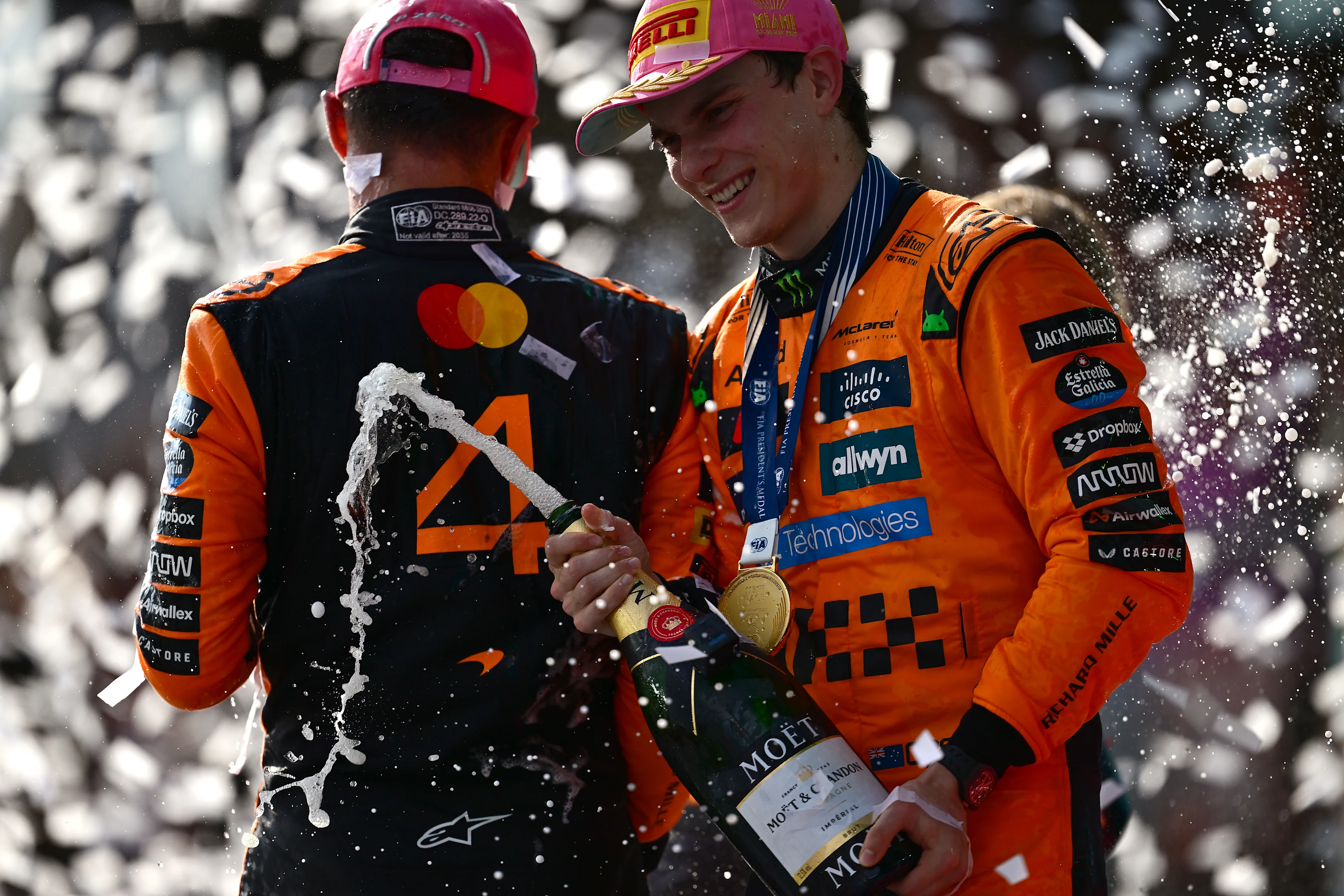 MIAMI, FLORIDA - MAY 04: Race winner Oscar Piastri of Australia and McLaren and Second placed Lando Norris of Great Britain and McLaren celebrate on the podium during the F1 Grand Prix of Miami at Miami International Autodrome on May 04, 2025 in Miami, Florida. (Photo by Mario Renzi - Formula 1/Formula 1 via Getty Images)