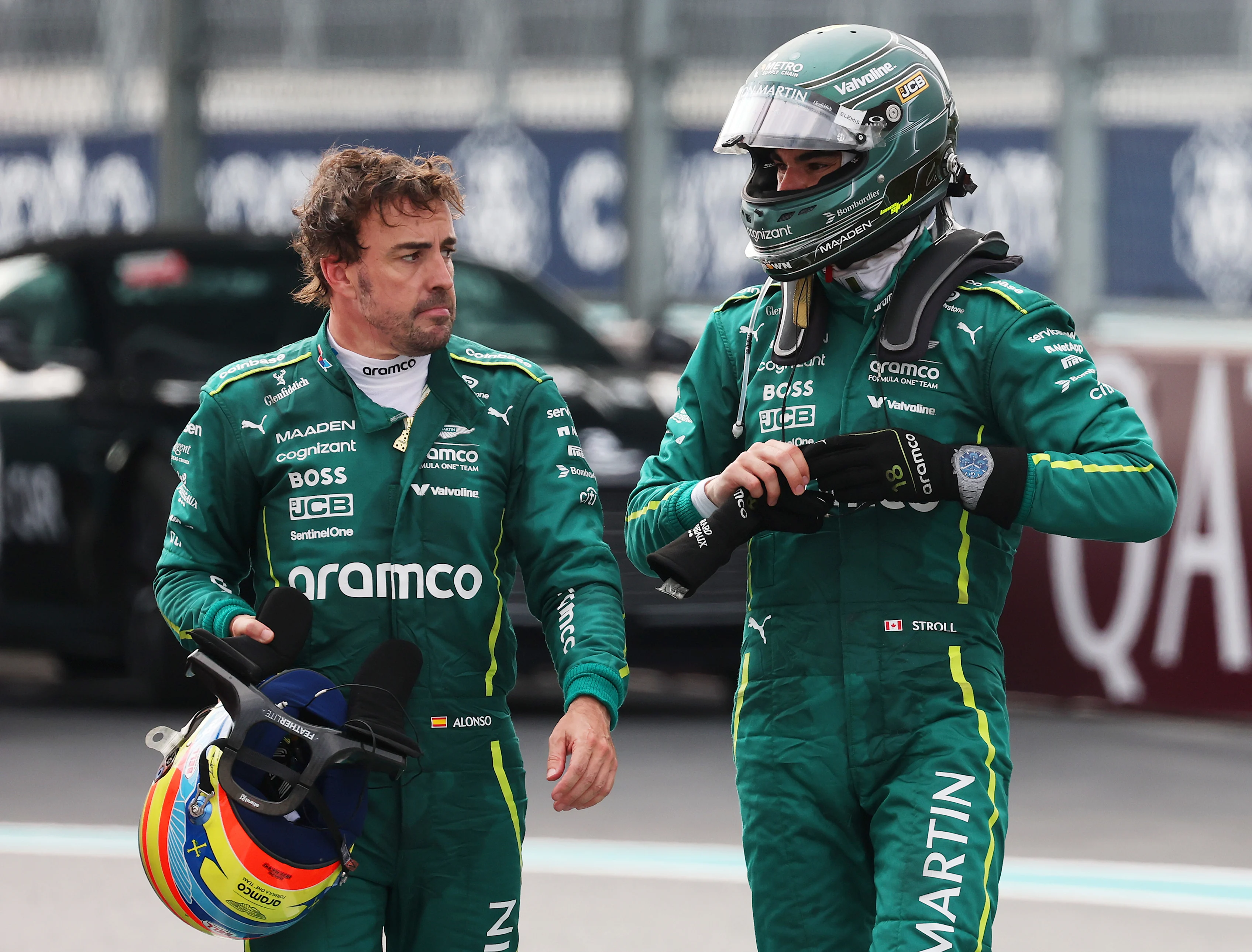 MIAMI, FLORIDA - MAY 04: Fifteenth placed Fernando Alonso of Spain and Aston Martin F1 Team and Sixteenth placed Lance Stroll of Canada and Aston Martin F1 Team talk in parc ferme during the F1 Grand Prix of Miami at Miami International Autodrome on May 04, 2025 in Miami, Florida. (Photo by Mark Thompson/Getty Images)