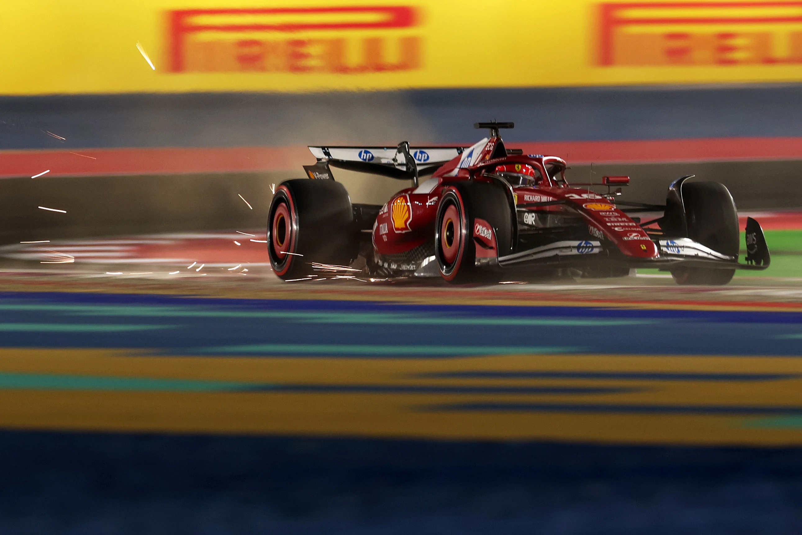 LUSAIL CITY, QATAR - NOVEMBER 29: Sparks fly behind Charles Leclerc of Monaco driving the (16)