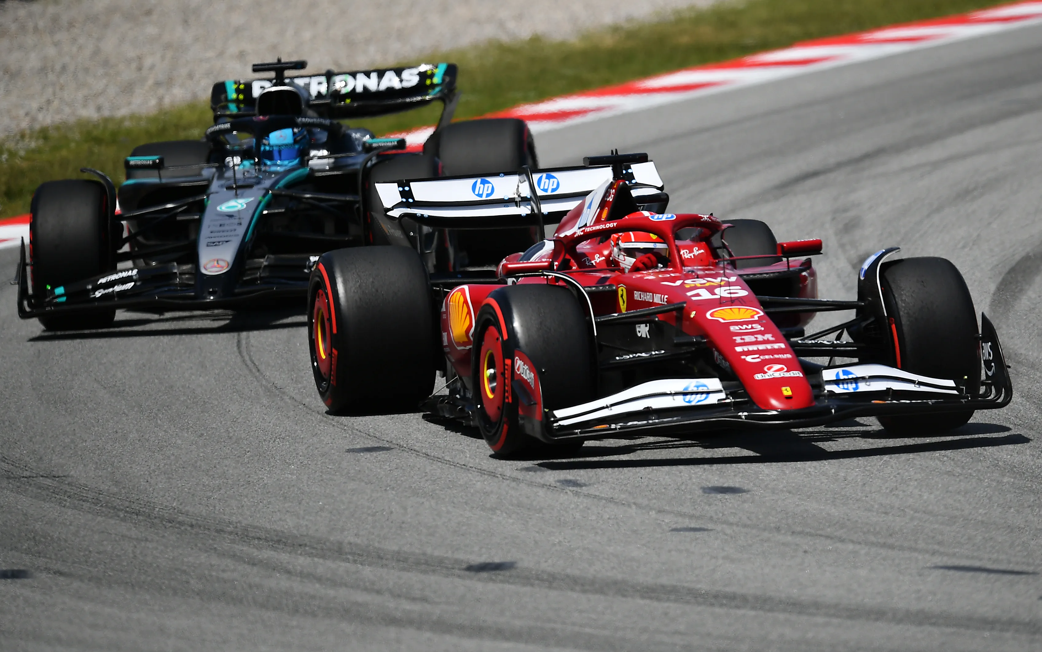BARCELONA, SPAIN - JUNE 01: Charles Leclerc of Monaco driving the (16) Scuderia Ferrari SF-25 leads George Russell of Great Britain driving the (63) Mercedes AMG Petronas F1 Team W16 on track during the F1 Grand Prix of Spain at Circuit de Barcelona-Catalunya on June 01, 2025 in Barcelona, Spain. (Photo by James Sutton - Formula 1/Formula 1 via Getty Images)