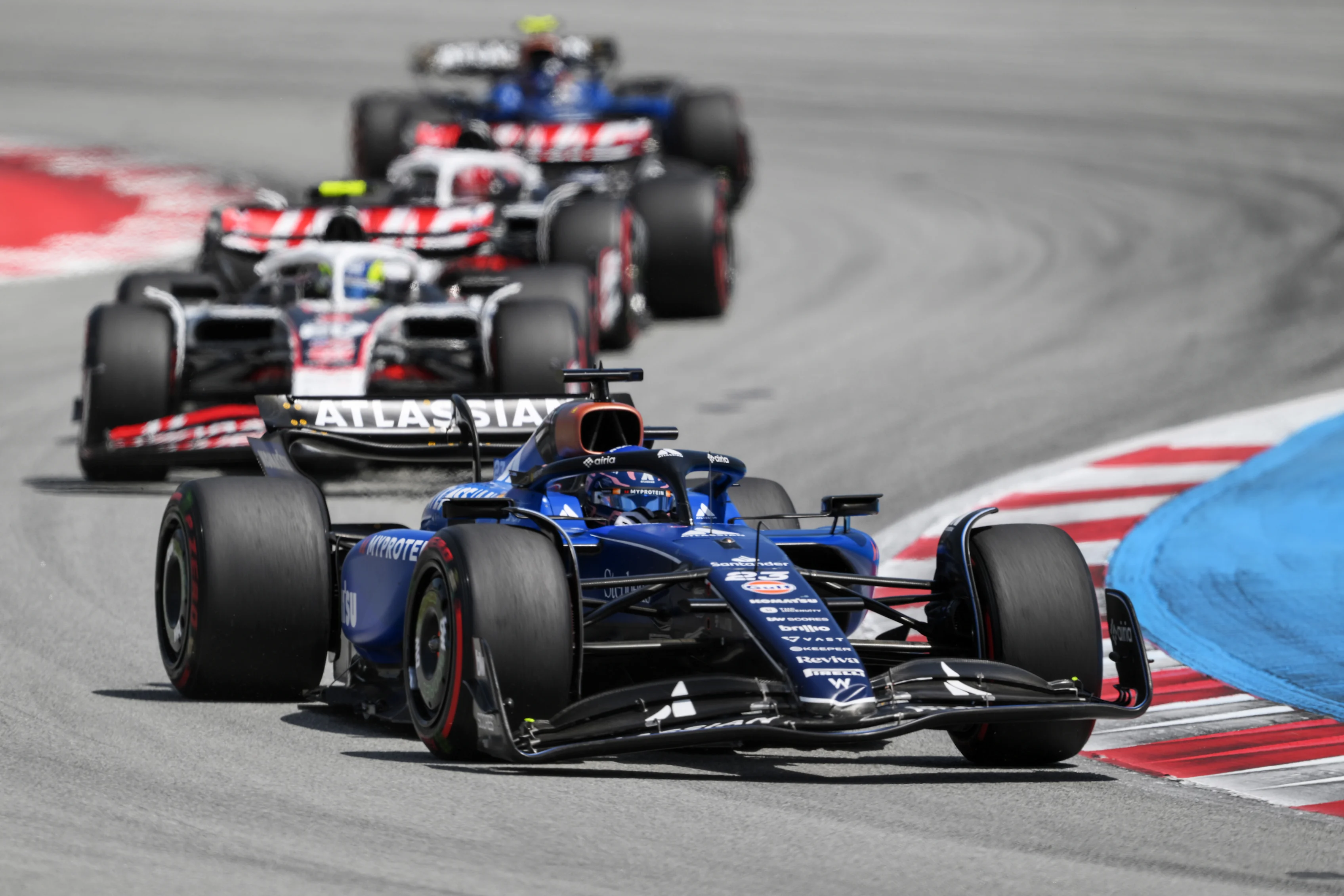 BARCELONA, SPAIN - JUNE 01: Alexander Albon of Thailand driving the (23) Williams FW47 Mercedes leads Oliver Bearman of Great Britain driving the (87) Haas F1 VF-25 Ferrari and Esteban Ocon of France driving the (31) Haas F1 VF-25 Ferrari on track during the F1 Grand Prix of Spain at Circuit de Barcelona-Catalunya on June 01, 2025 in Barcelona, Spain. (Photo by David Ramos/Getty Images)