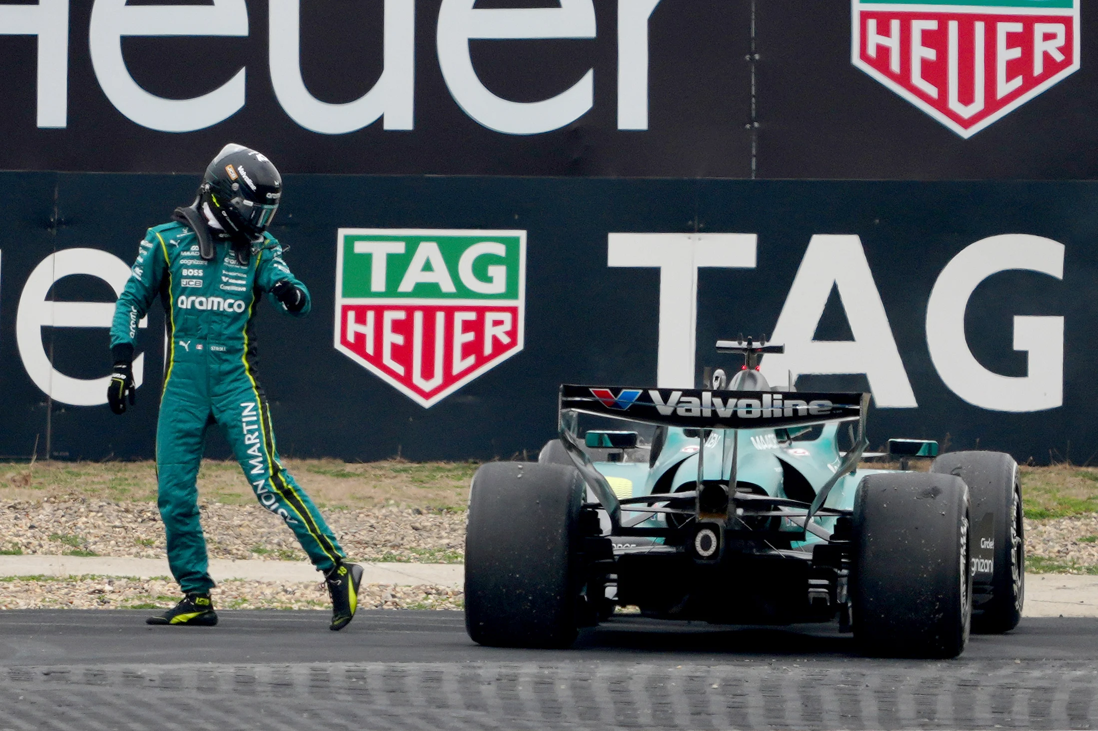 SHANGHAI, CHINA - MARCH 15: Lance Stroll of Canada and Aston Martin F1 Team walks away from his car