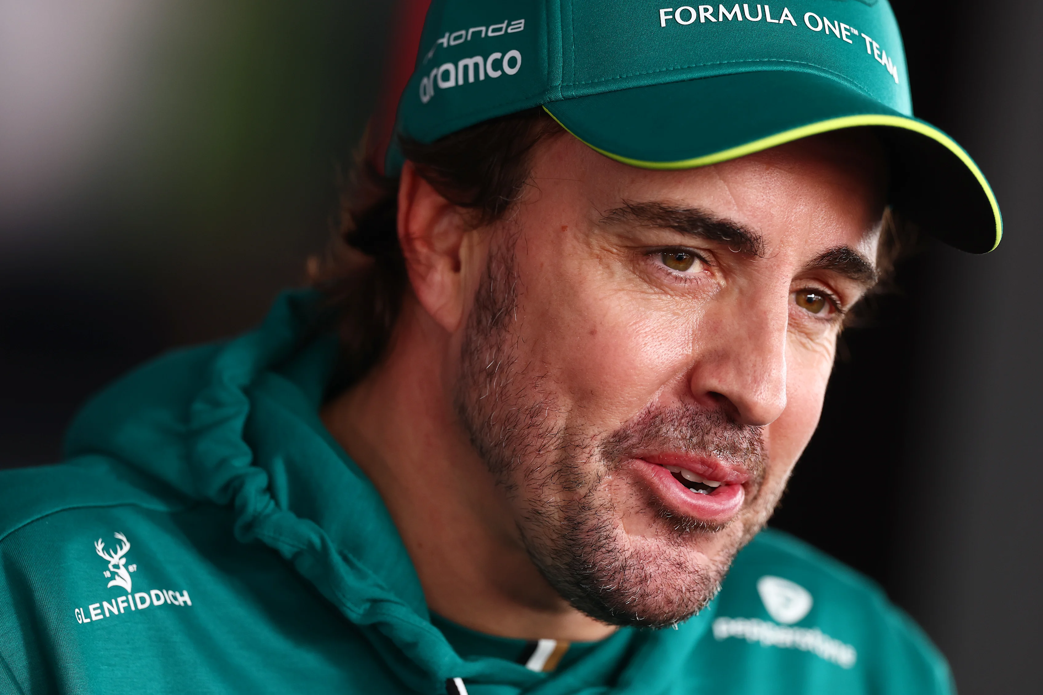 SUZUKA, JAPAN - MARCH 28: Twenty-first placed qualifier Fernando Alonso of Spain and Aston Martin