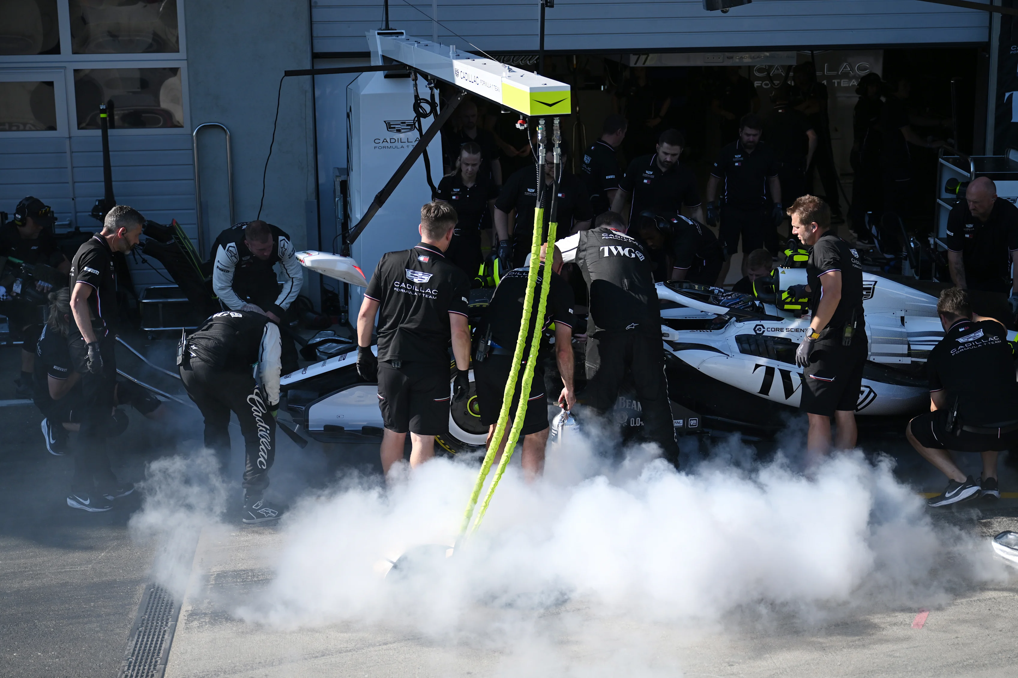 SPIELBERG, AUSTRIA - JUNE 26: Cadillac F1 Team personnel extinguish a fire on the car of Sergio
