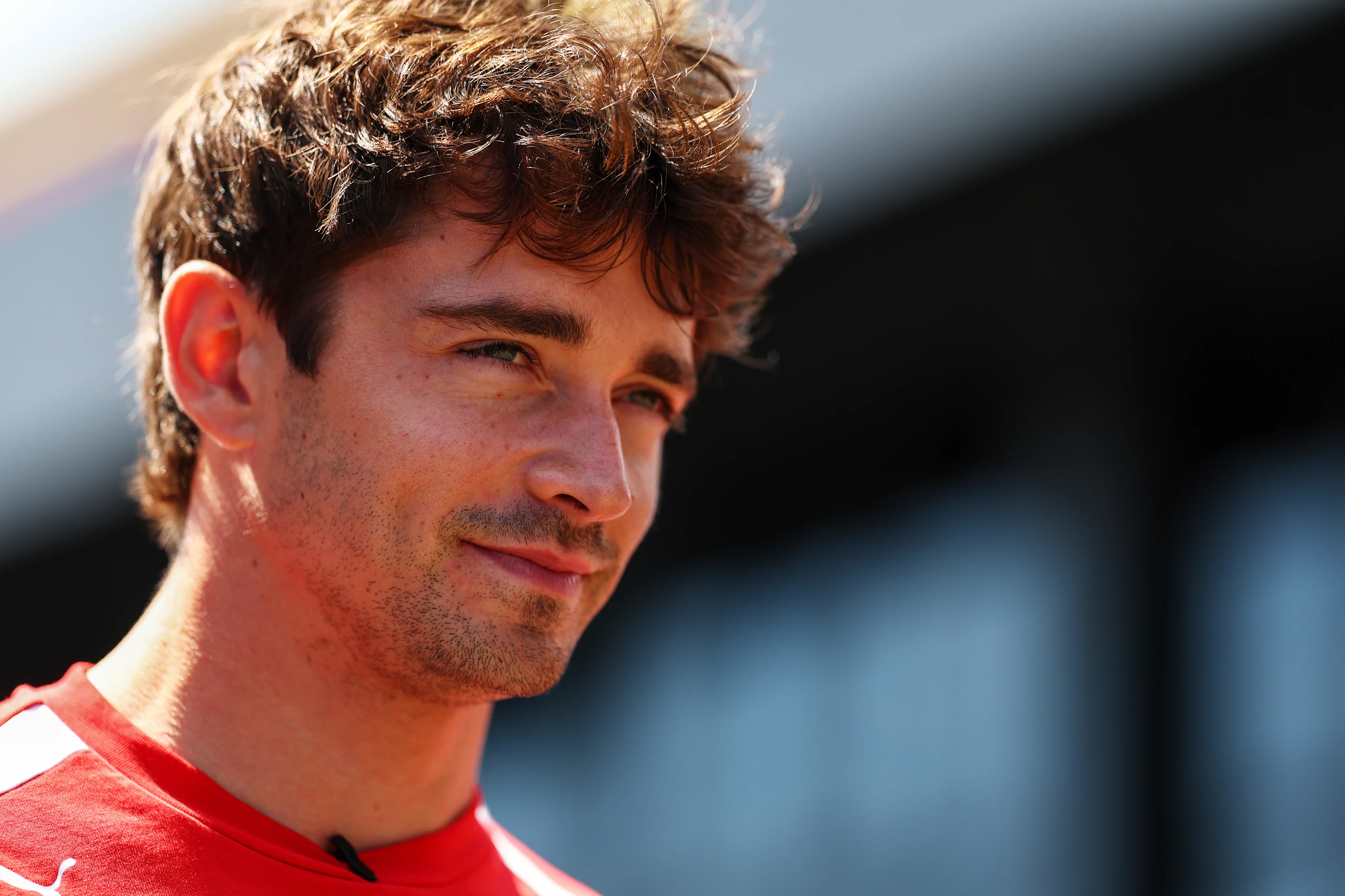 SPIELBERG, AUSTRIA - JUNE 25: Charles Leclerc of Monaco and Scuderia Ferrari walks in the Paddock