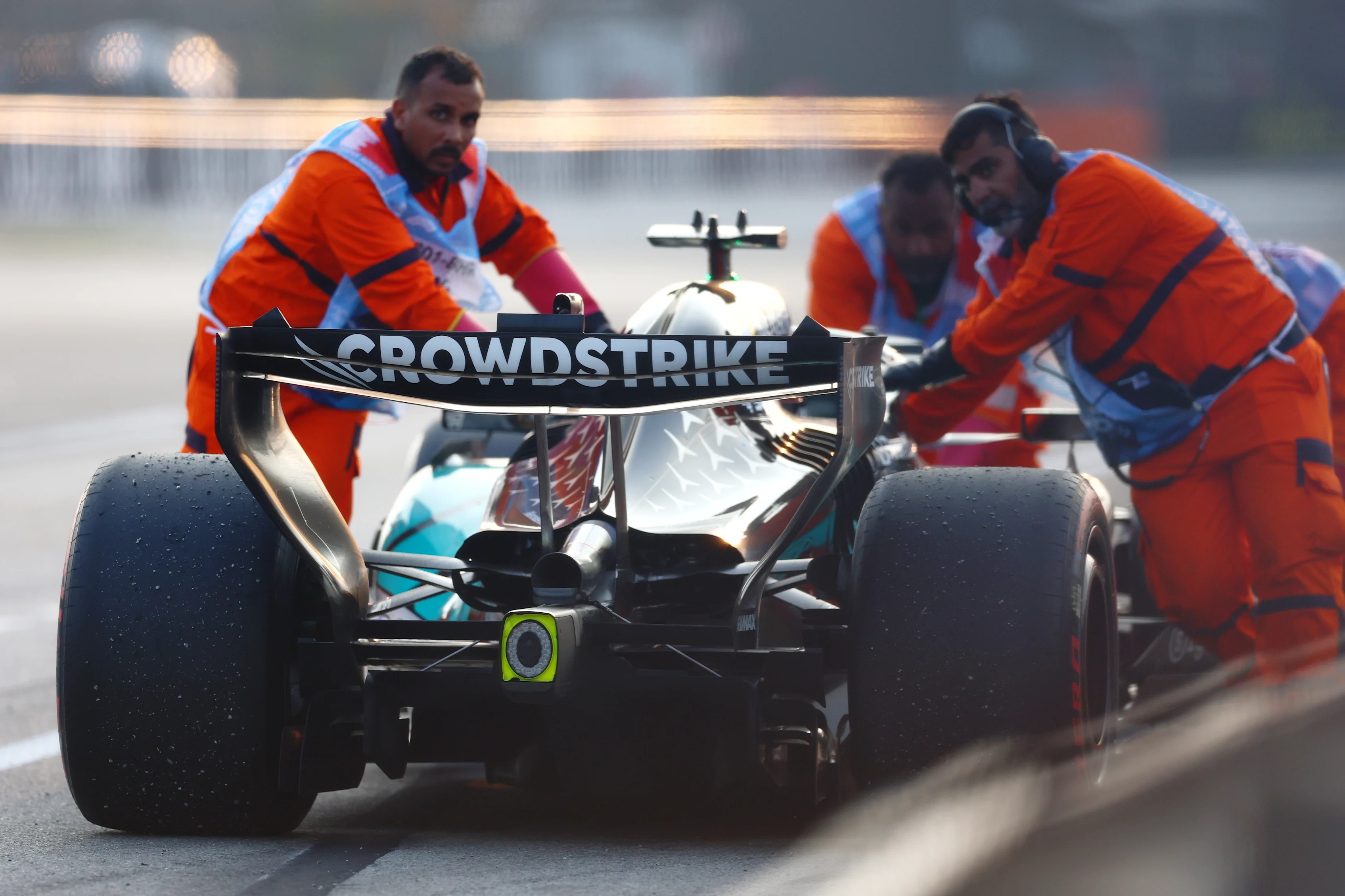 KUALA LUMPUR, MALAYSIA - OCTOBER 04: Marshals move the car of George Russell of Great Britain and