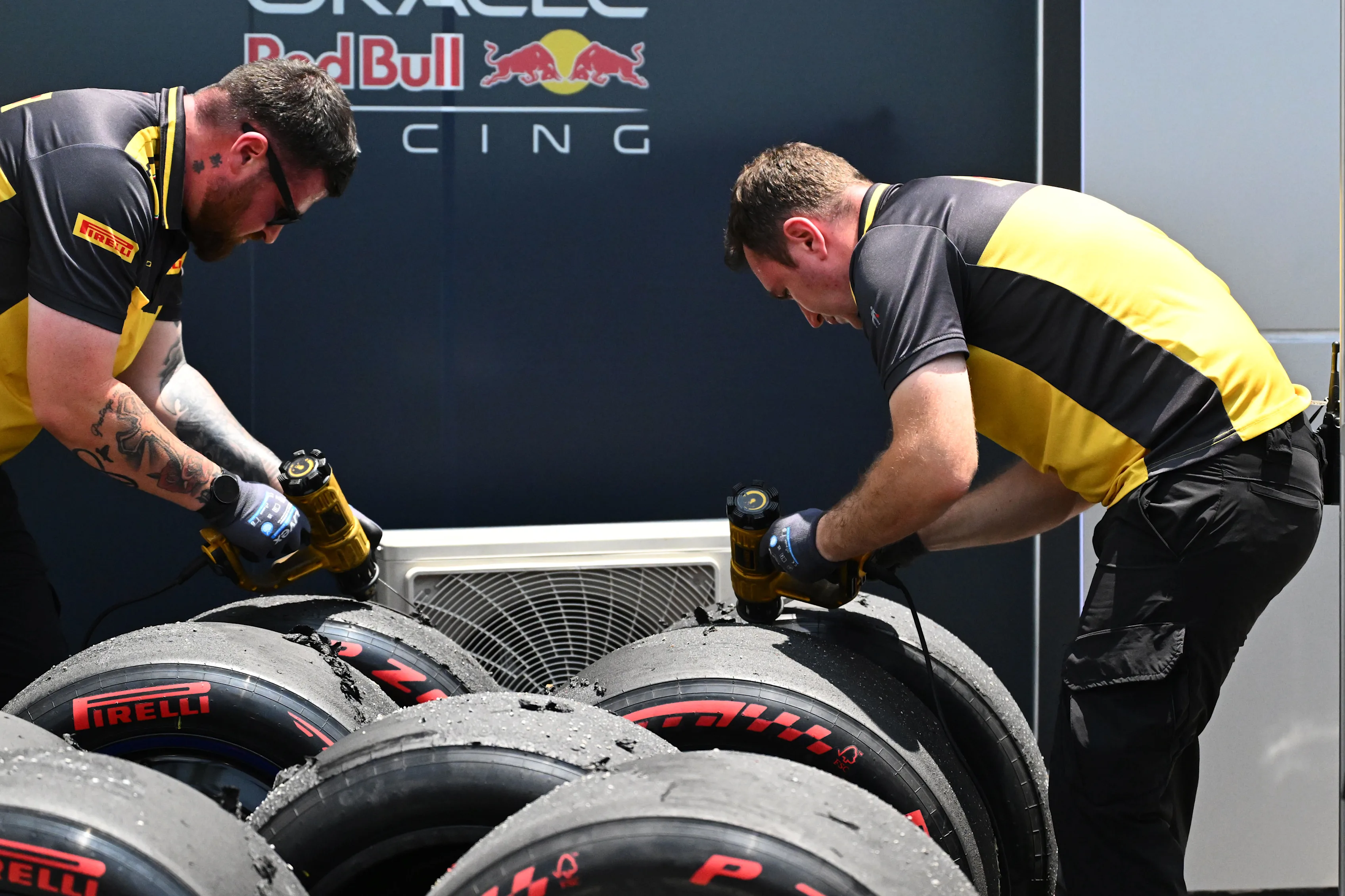 KUALA LUMPUR, MALAYSIA - OCTOBER 02: Pirelli technicians work on some tyres during practice ahead