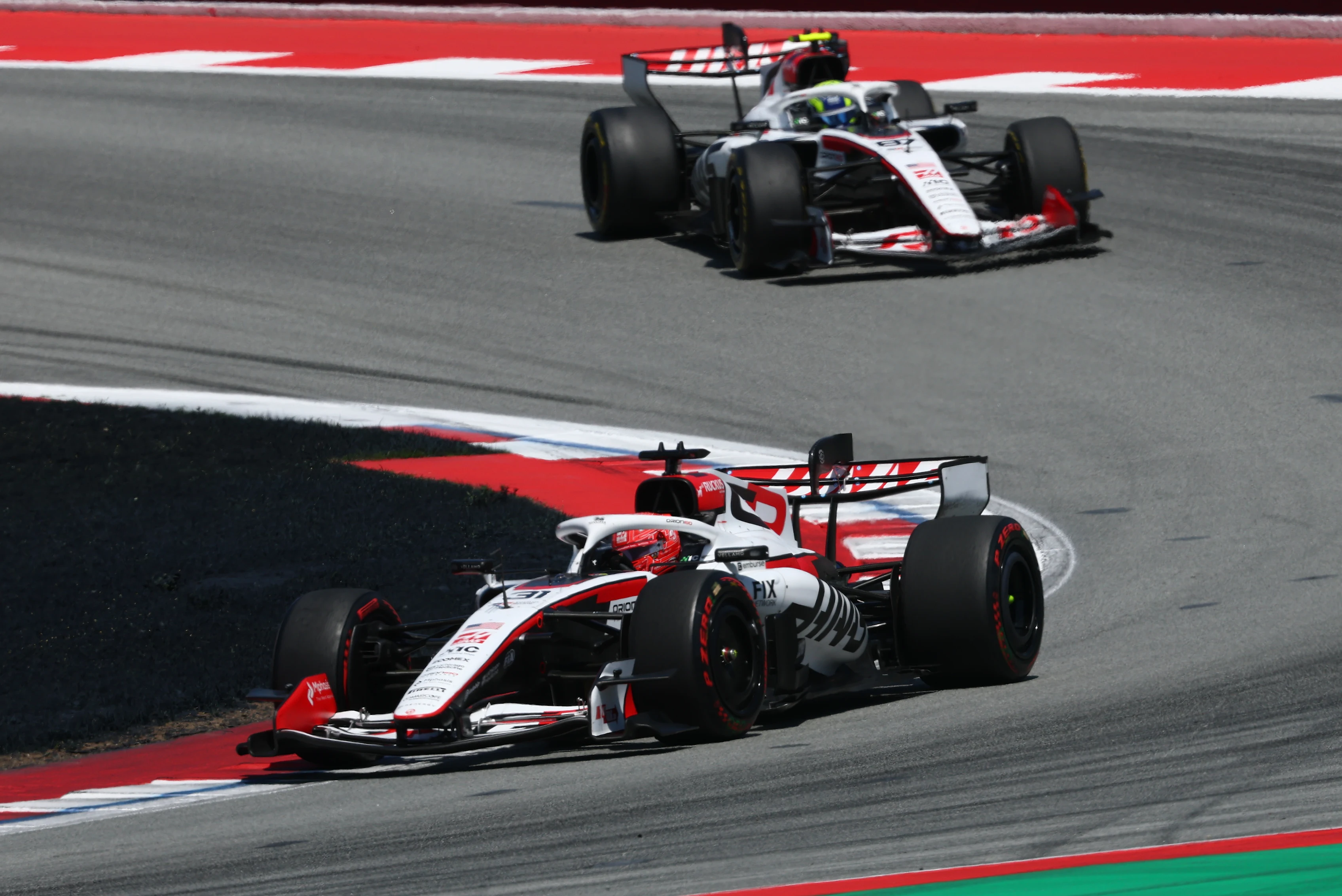 BARCELONA, SPAIN - JUNE 14: Esteban Ocon of France driving the (31) Haas F1 VF-26 Ferrari leads