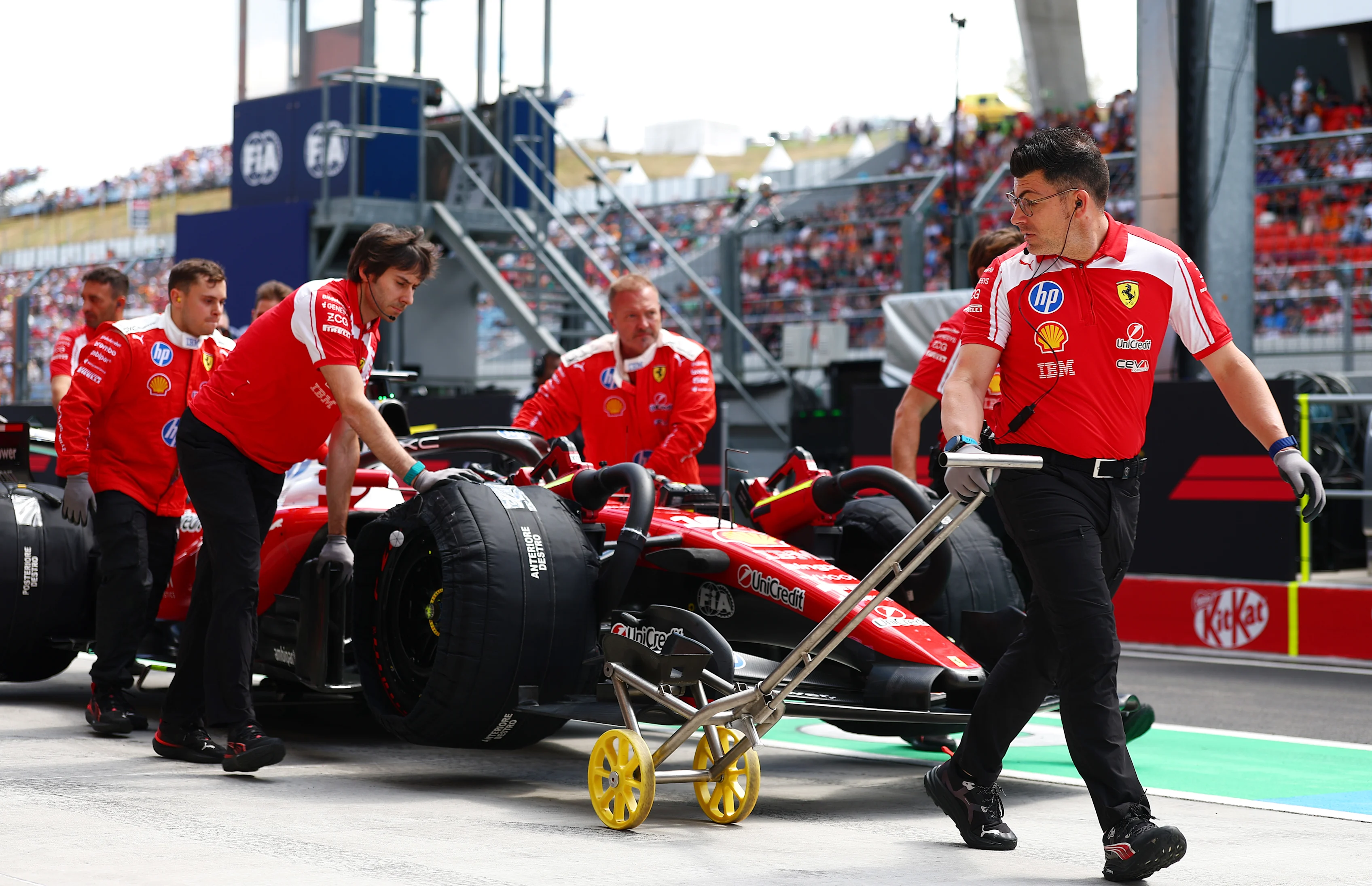 BUDAPEST, HUNGARY - JULY 24: Ferrari mechanics move the car of Charles Leclerc of Monaco and