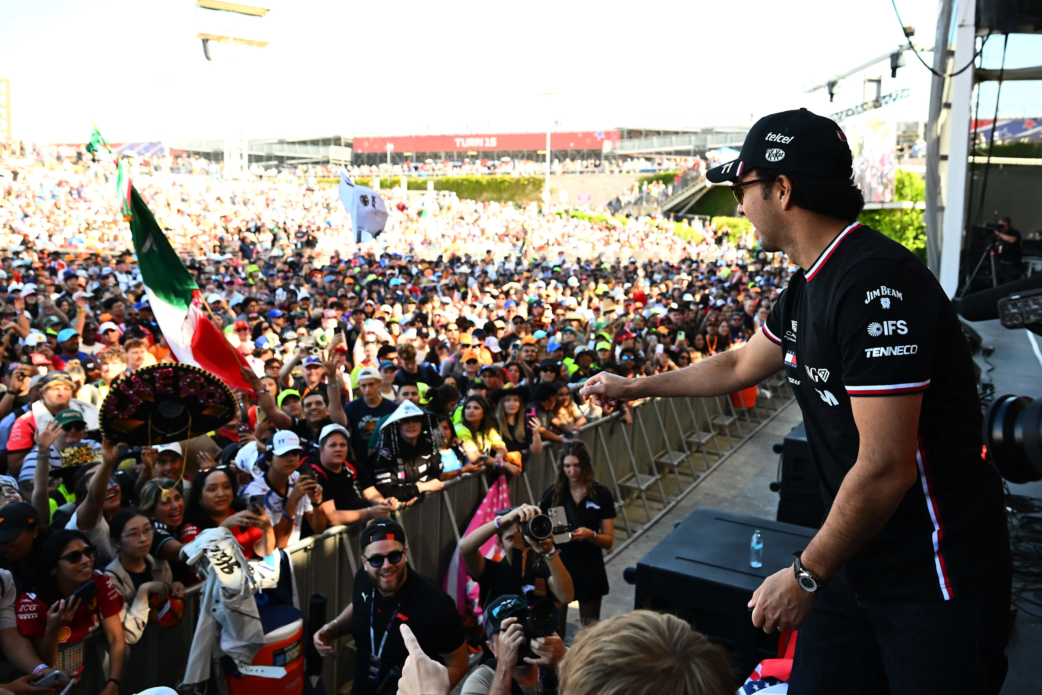 AUSTIN, TEXAS - OCTOBER 23: Sergio Perez of Mexico and Cadillac F1 Team throws hats from the stage