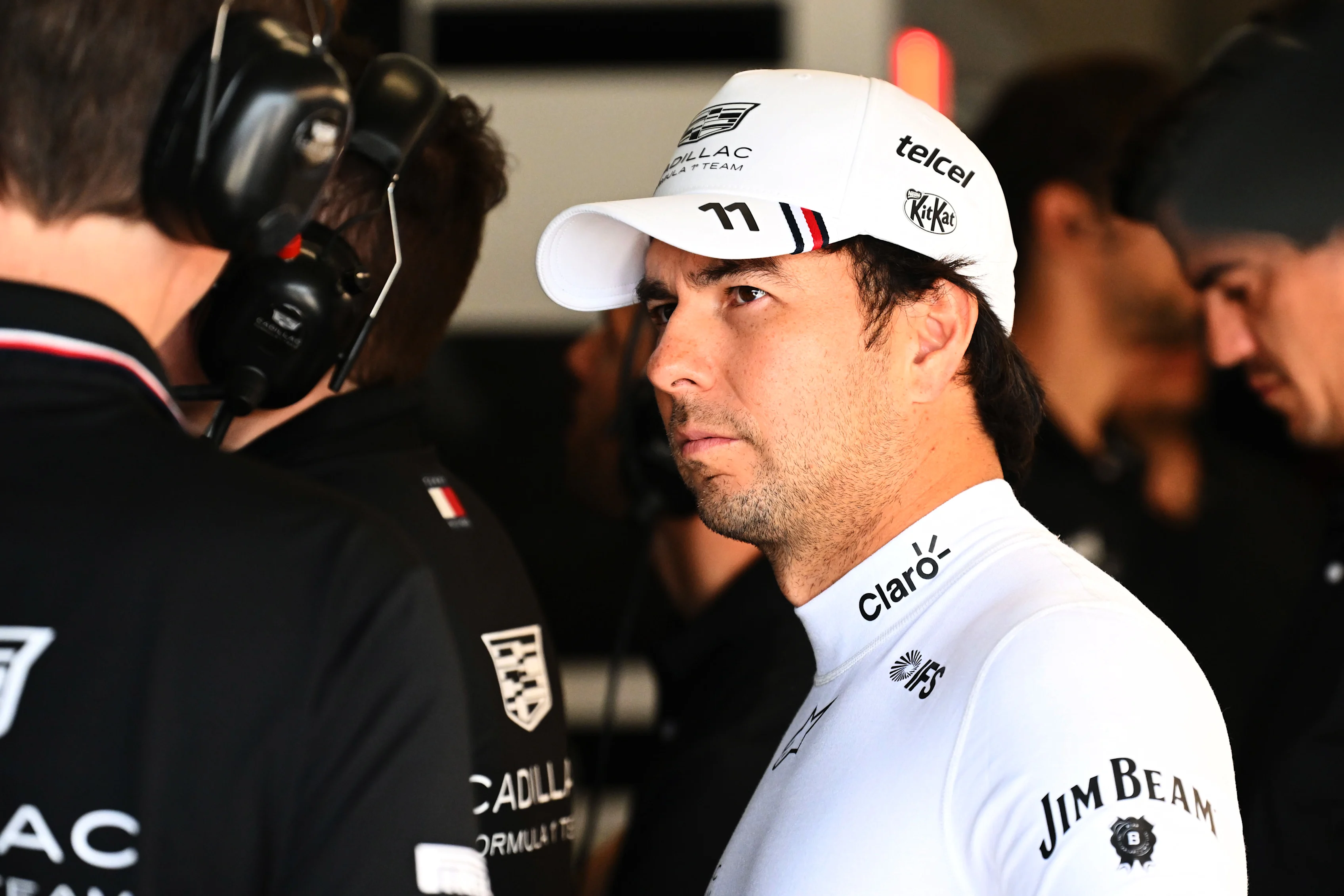AUSTIN, TEXAS - OCTOBER 24: Sergio Perez of Mexico and Cadillac F1 Team talks with his engineers in
