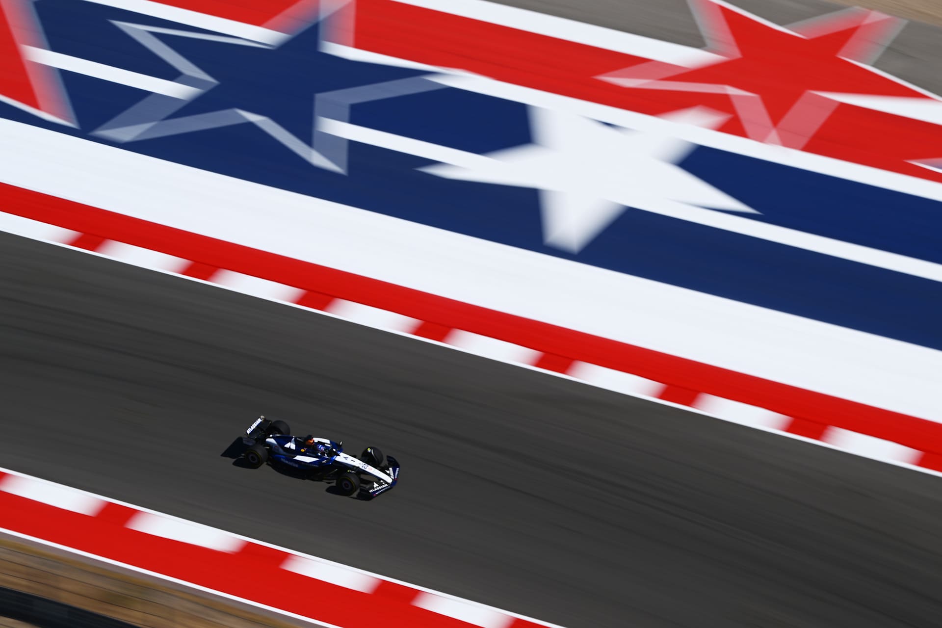 Alex Albon’s Williams beside the large red-white-blue COTA run-off design in 2025.