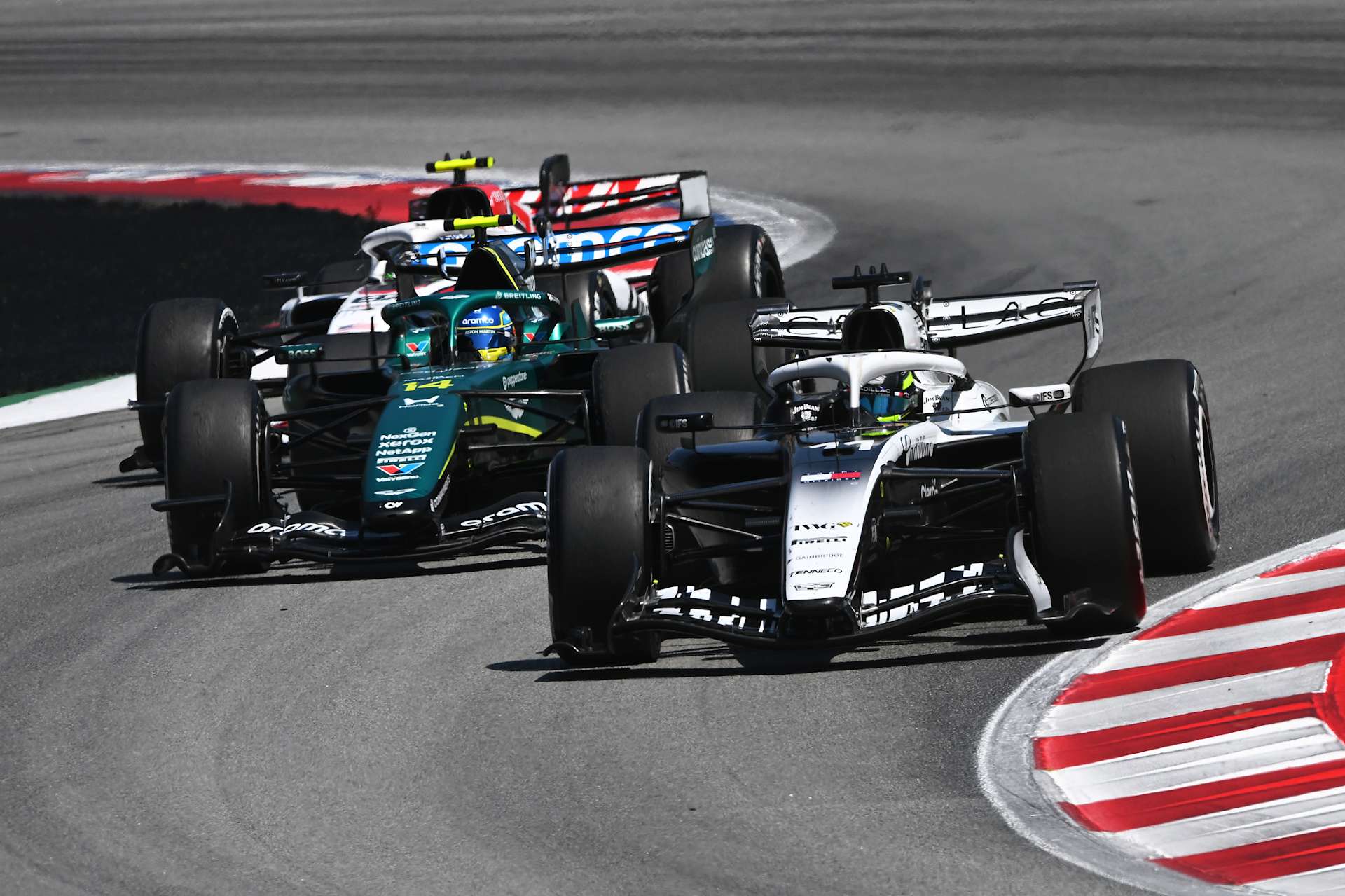 An actual 2026 Cadillac leading an Aston Martin and Haas in Barcelona.