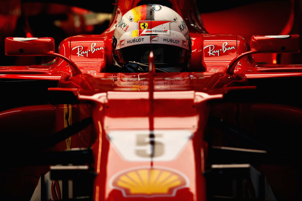 SUZUKA, JAPAN - OCTOBER 07: Sebastian Vettel of Germany and Ferrari prepares to drive in the