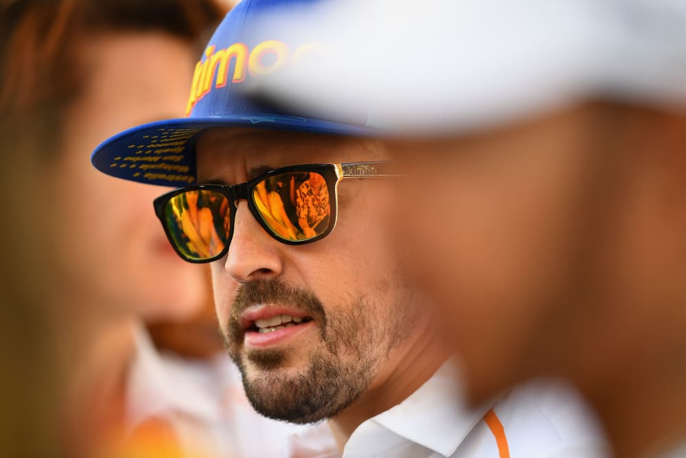 ABU DHABI, UNITED ARAB EMIRATES - NOVEMBER 22: Fernando Alonso of Spain and McLaren F1 talks to
