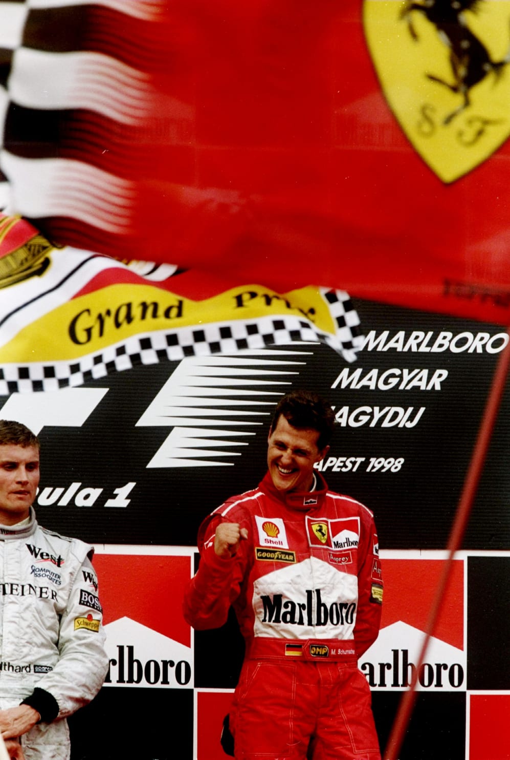 14-16 Aug 1998: Ferrari driver Michael Schumacher of Germany celebrates after his victory in the