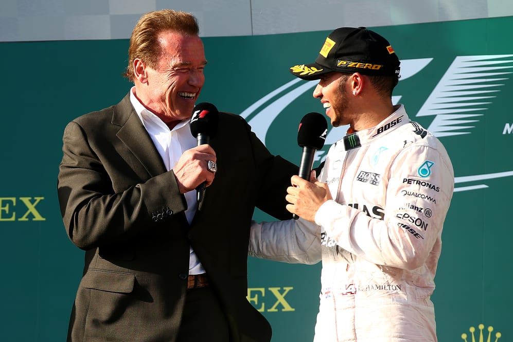 MELBOURNE, AUSTRALIA - MARCH 15: Lewis Hamilton of Great Britain and Mercedes GP speaks with actor