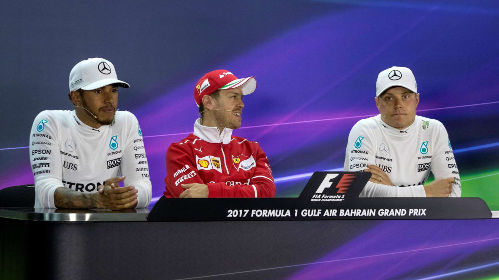 Sebastian Vettel takes a look at Lewis Hamilton's trophy during the press  conference, British Grand Prix photos