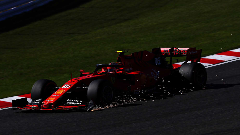 SUZUKA, JAPAN - OCTOBER 13: Sparks fly from the broken front wing of Charles Leclerc of Monaco
