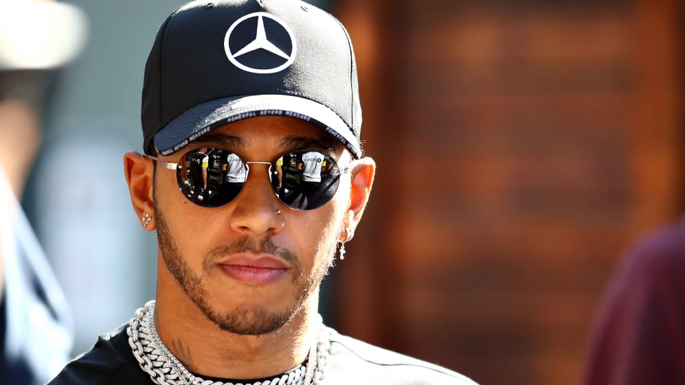 MELBOURNE, AUSTRALIA - MARCH 12: Lewis Hamilton of Great Britain and Mercedes GP walks in the