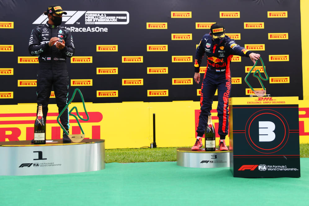 SPIELBERG, AUSTRIA - JULY 12: Max Verstappen of Netherlands and Red Bull Racing reaches to collect