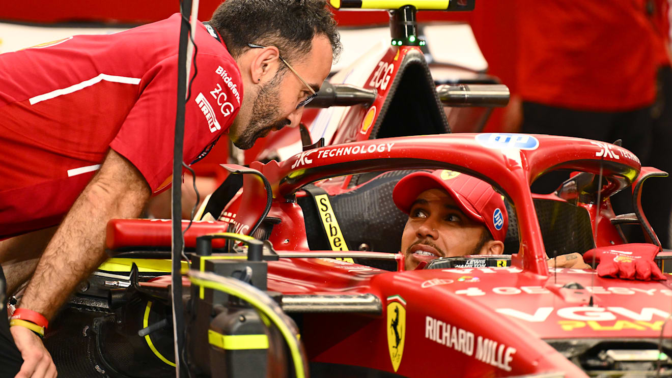 JEDDAH, SAUDI ARABIA - APRIL 17: Lewis Hamilton of Great Britain and Scuderia Ferrari talks with a
