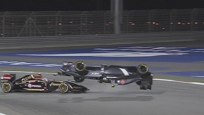 Pastor Maldonado's Lotus collides with the Sauber of Esteban Gutierrez at Turn 1, flipping it over and bringing out the safety car. © FOWC Ltd