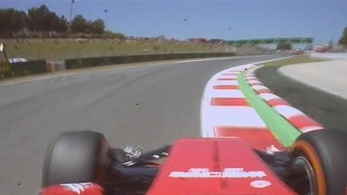 Fernando Alonso fights his Ferrari F14 T as he rumbles over the kerbs at Turn 8. © FOWC Ltd