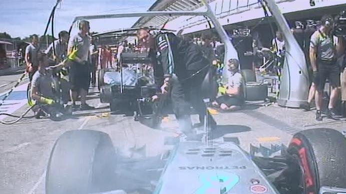 Nico Rosberg's brakes smoke as he waits for team mate Lewis Hamilton to leave the Mercedes pit box. © FOWC Ltd
