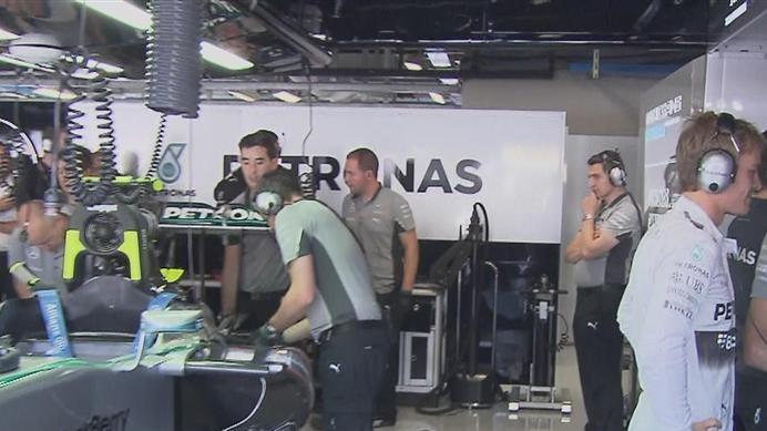Nico Rosberg watches the action from the Mercedes garage, while his mechanics work on a gearbox issue that rules him out of FP3. © FOWC Ltd