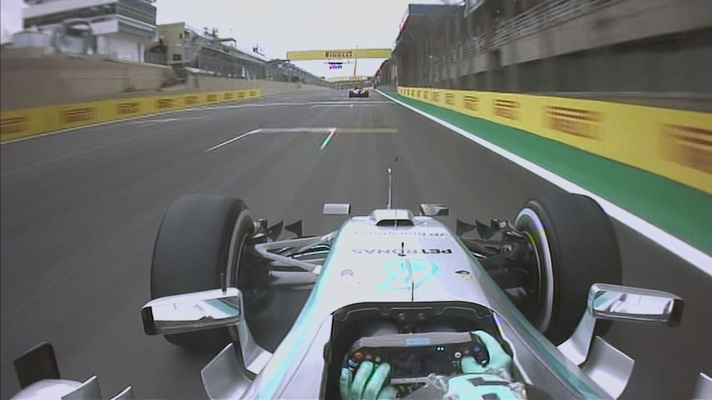 Rosberg adjusts some settings on his steering wheel at high speed