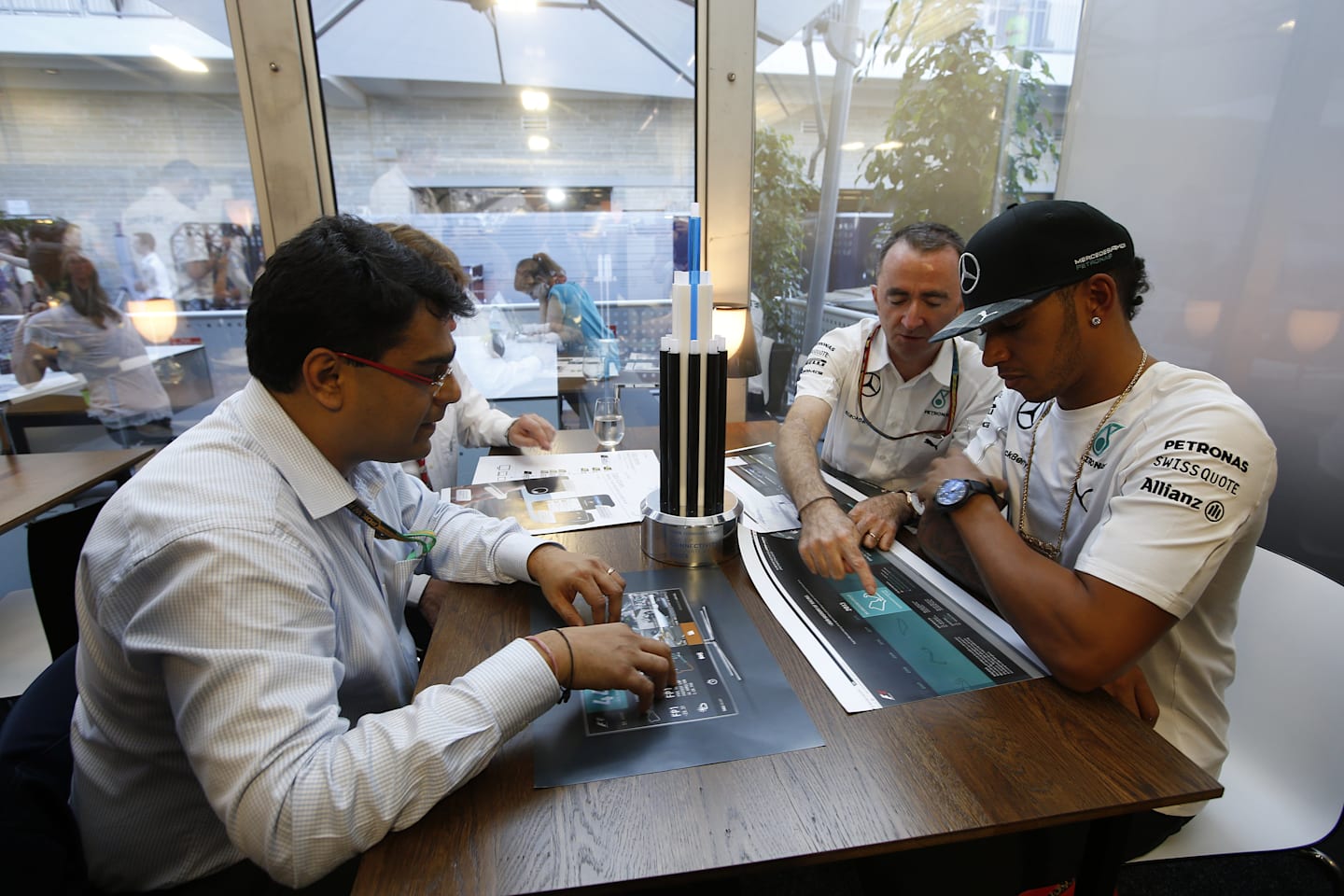 Judges discuss Tata Communications' inaugural F1 Connectivity Innovation Prize: (L to R) Mehul Kapadia, MD of the F1 Business, Tata Communications, Mercedes AMG Petronas team Executive Director (Technical), Paddy Lowe, and Mercedes driver Lewis Hamilton. © Tata Communications