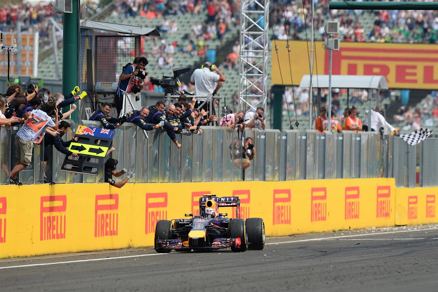 Race winner Daniel Ricciardo (AUS) Red Bull Racing RB10 crosses the line. Formula One World Championship, Rd11, Hungarian Grand Prix, Race Day, Hungaroring, Hungary. Sunday, 27 July 2014. © Sutton Images